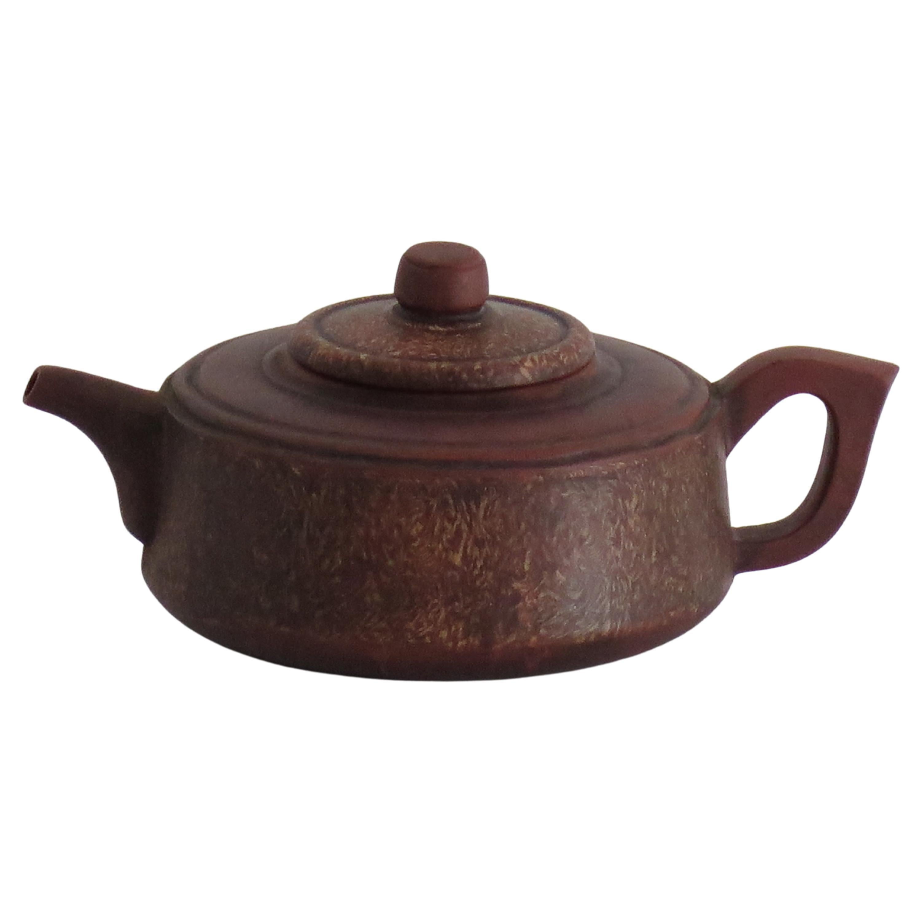 This is an antique Chinese hand potted Red Clay YIXING Teapot and cover, fully marked and dating  to the early 20th Century.

The Teapot and lid are hand-potted in an interesting compressed squat shape and made of Red Clay stoneware. The lid has a