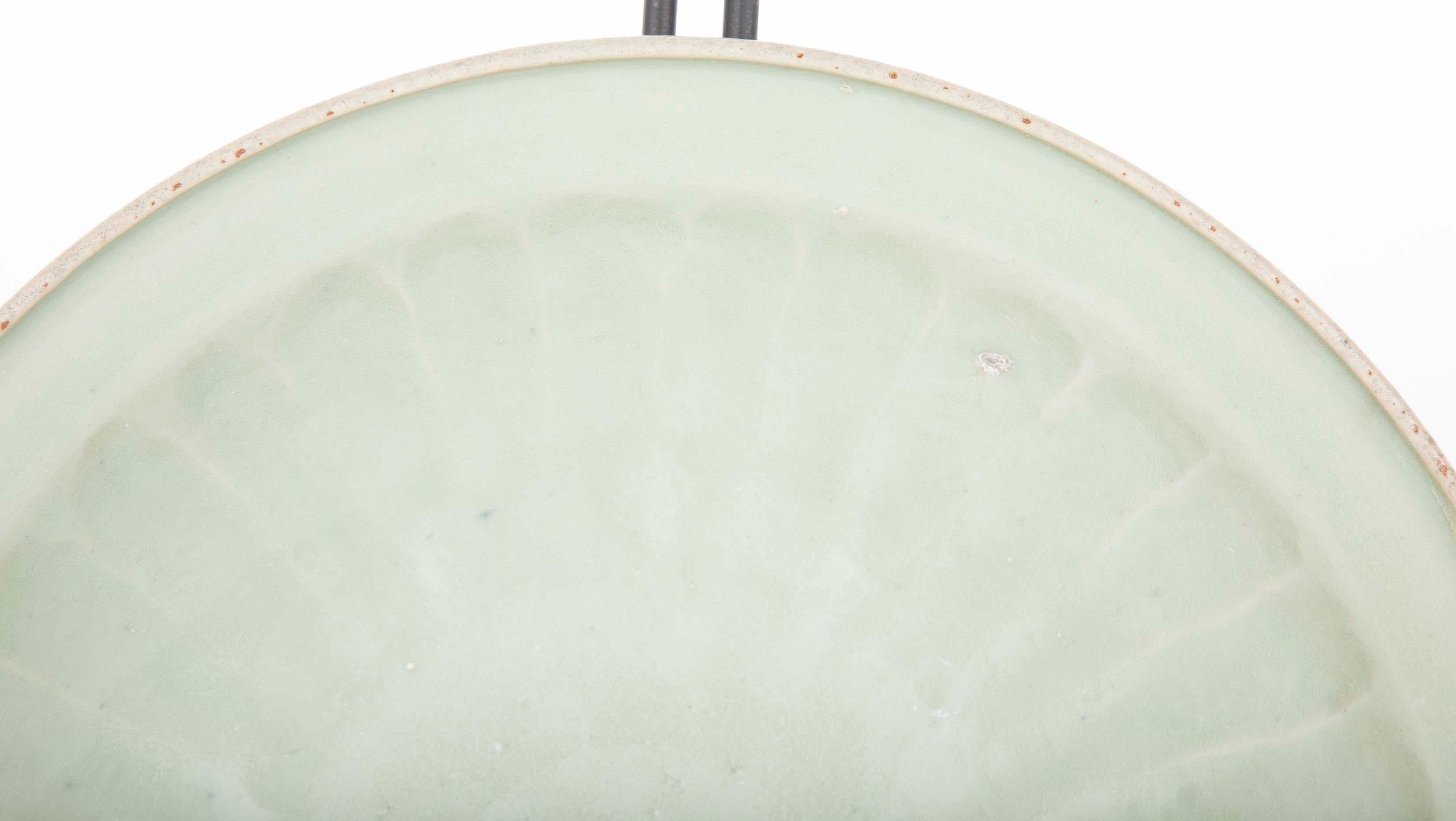 A beautiful Chinese Yuan celadon plate in green glaze finish having fluted edges.