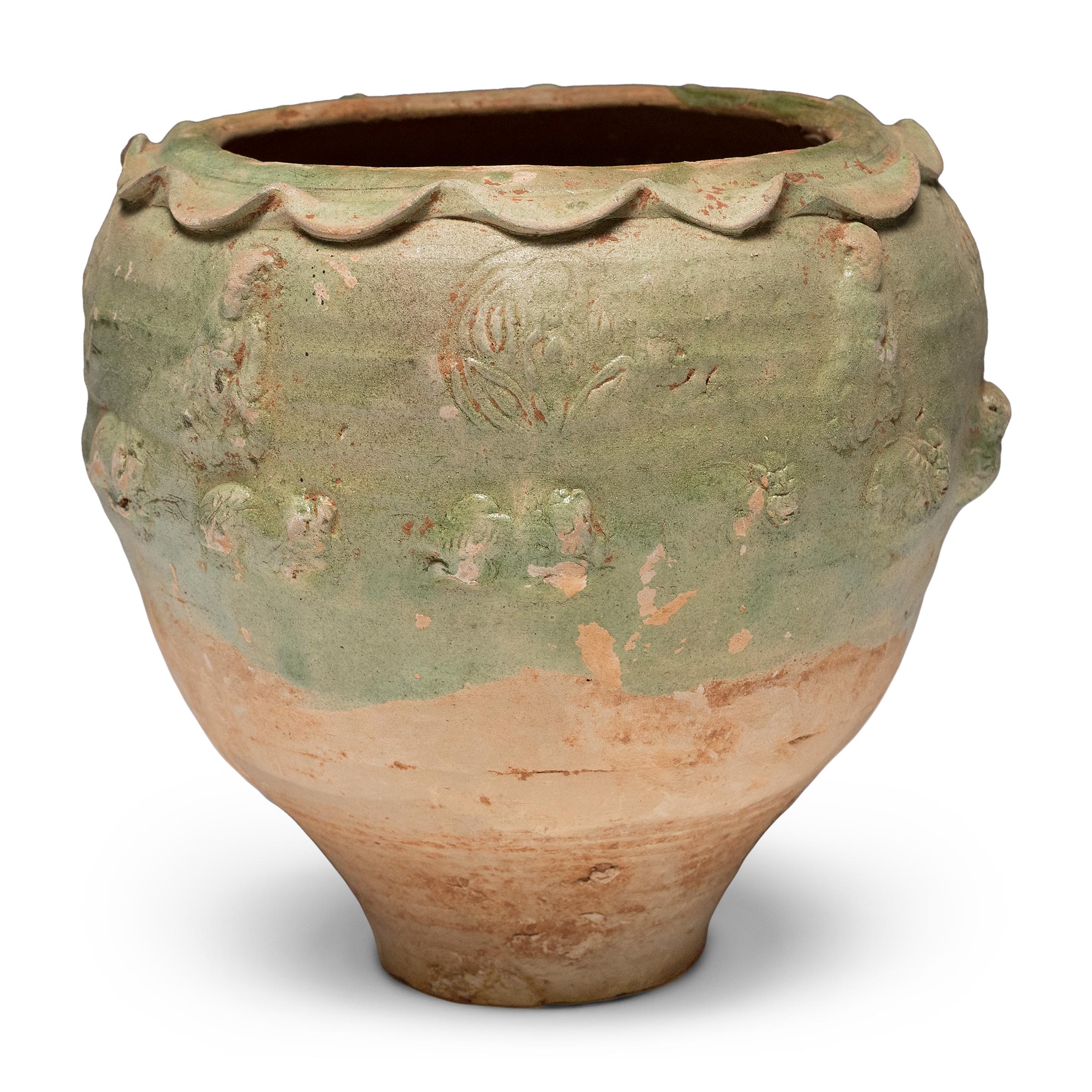 Beautiful in its imperfection, this green glazed jar from Yunnan province is an offering vessel, or spirit jar, originally filled with ritual offerings such as coins, shells, flowers and grains. Attributed to the Yuan dynasty (1271-1368) or earlier,