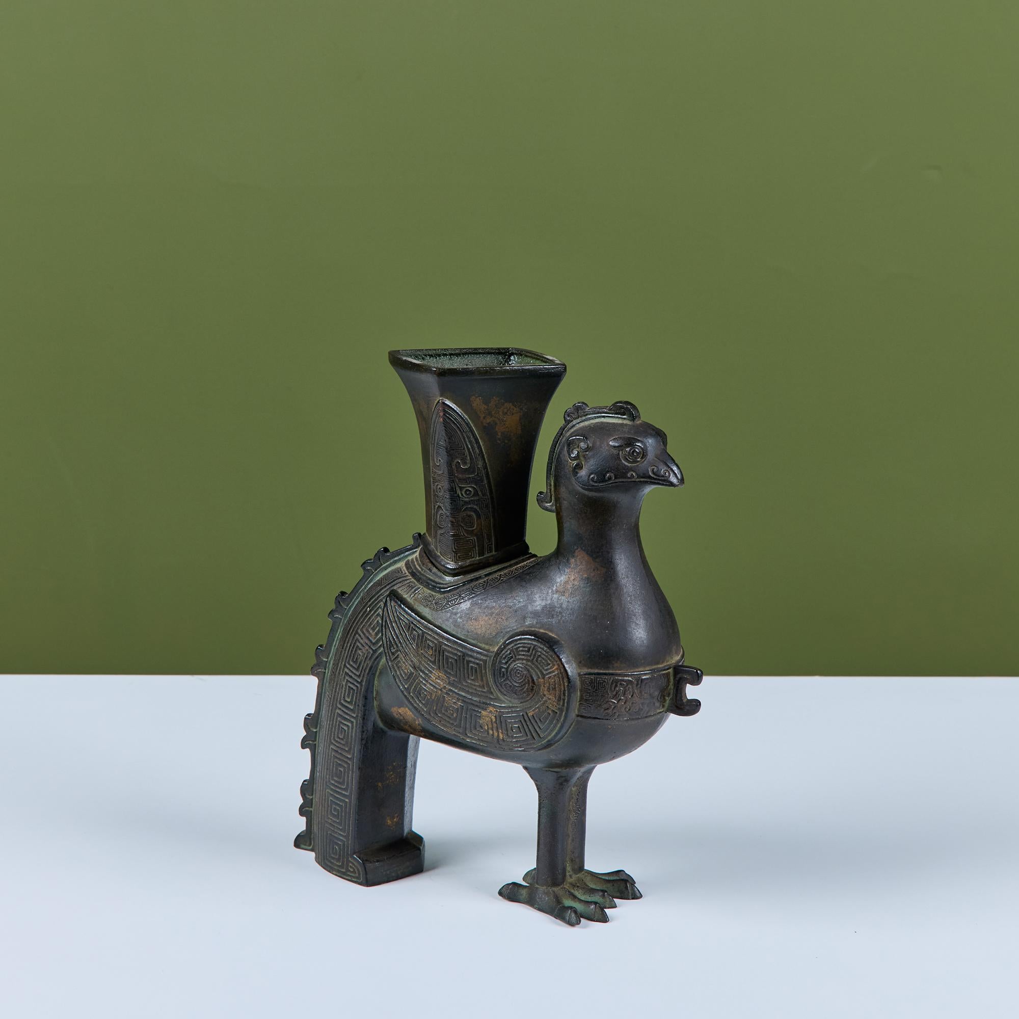 Patinated bronze Chinese Zun vessel. Originally a ritual container to hold wine, this piece could also be used as a decorative vase or sculptural element.

Dimensions
10