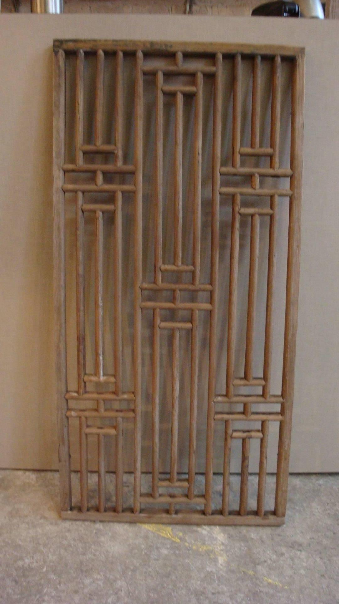 This is a pair of Chinese, circa late 1900 wood window panels in a geometric pattern.