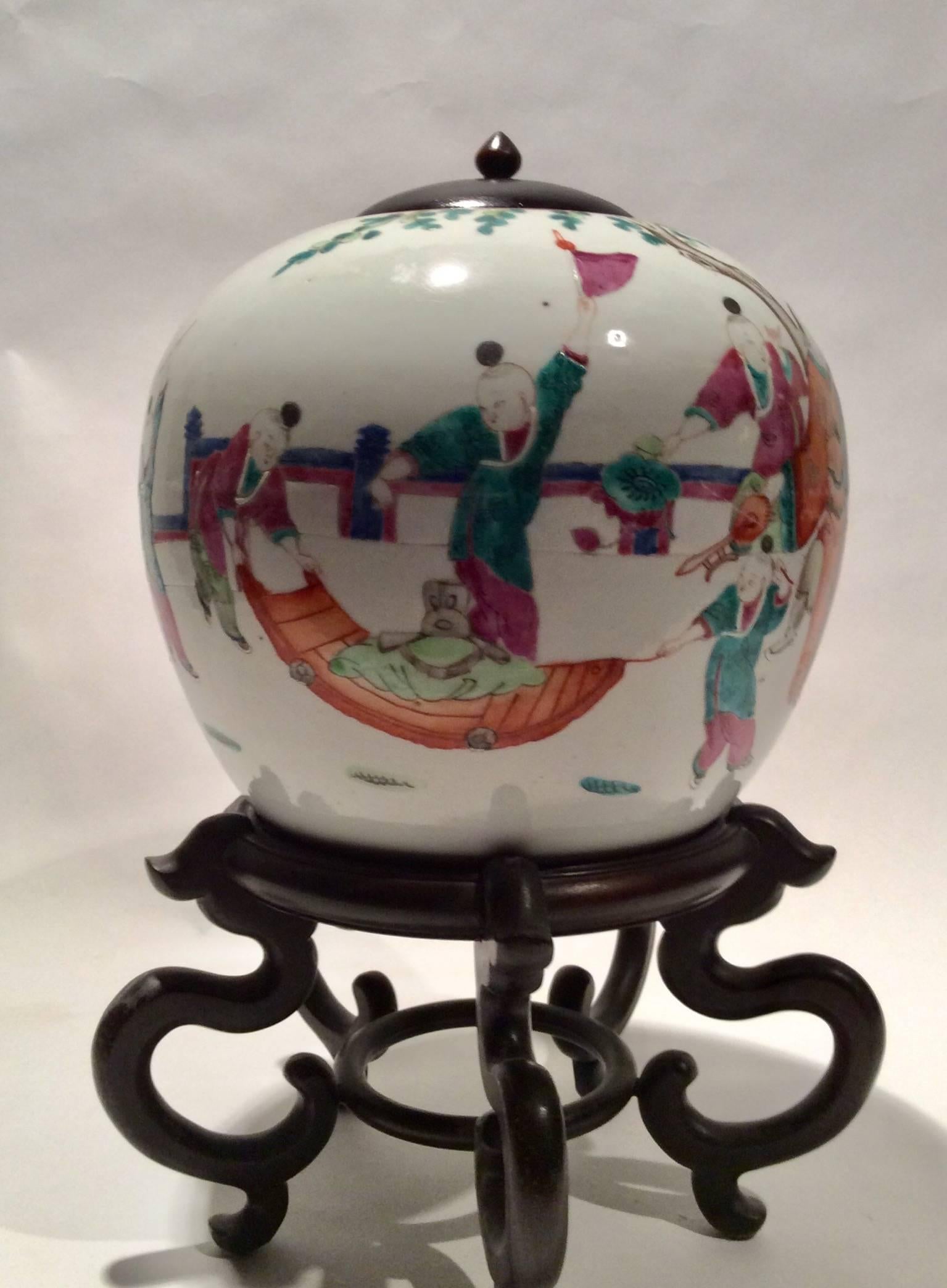 This porcelain jar is typical of pieces from the Tung Chih period of the late Ching dynasty (1862-1875) hand-painted in Famille Rose palette depicting a playful scene with children.