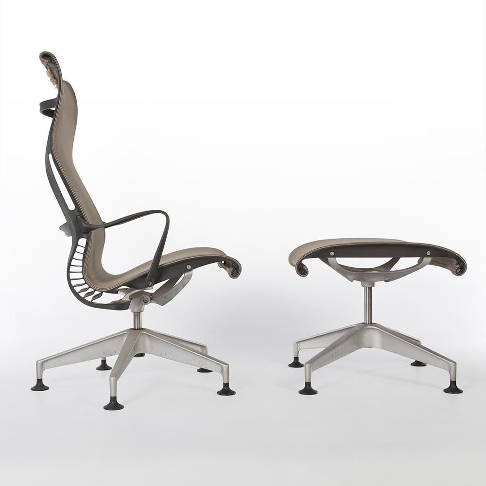 A newer design, this is an original Setu lounge chair and ottoman by Studio 7.5 for Herman Miller. This revolutionary chair uses a malleable polypropylene skeleton instead of the tradition 'torsion bar' to allow the chair to tilt backwards. The mesh