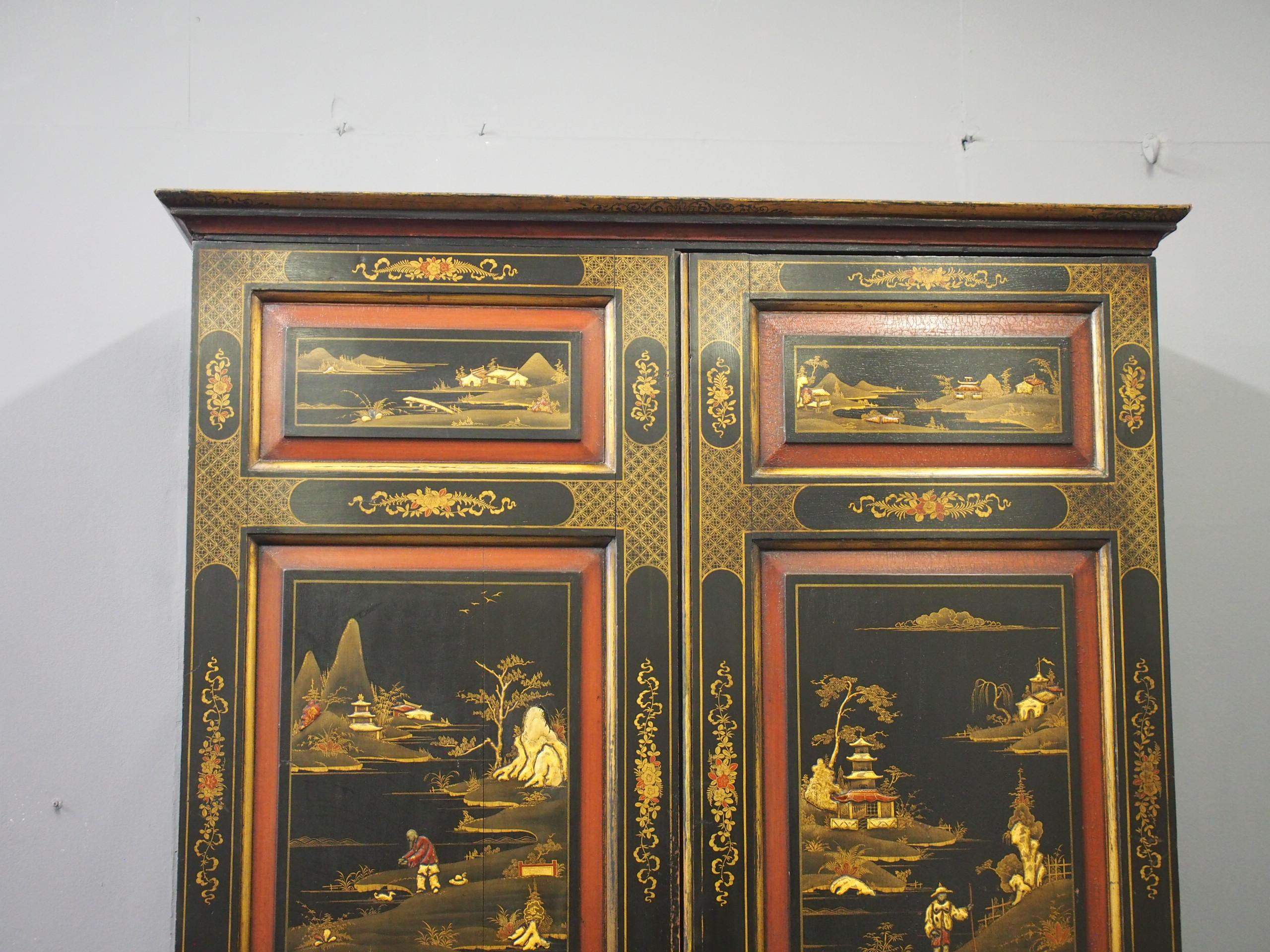 Georgian style chinoiserie 2-door wardrobe, circa 1880. Painted and lacquered, with a moulded cornice and gilding with Chinese motifs to the 6 fielded panels in the 2 full length doors. The painted designs continue to the gables, and inside it has 2