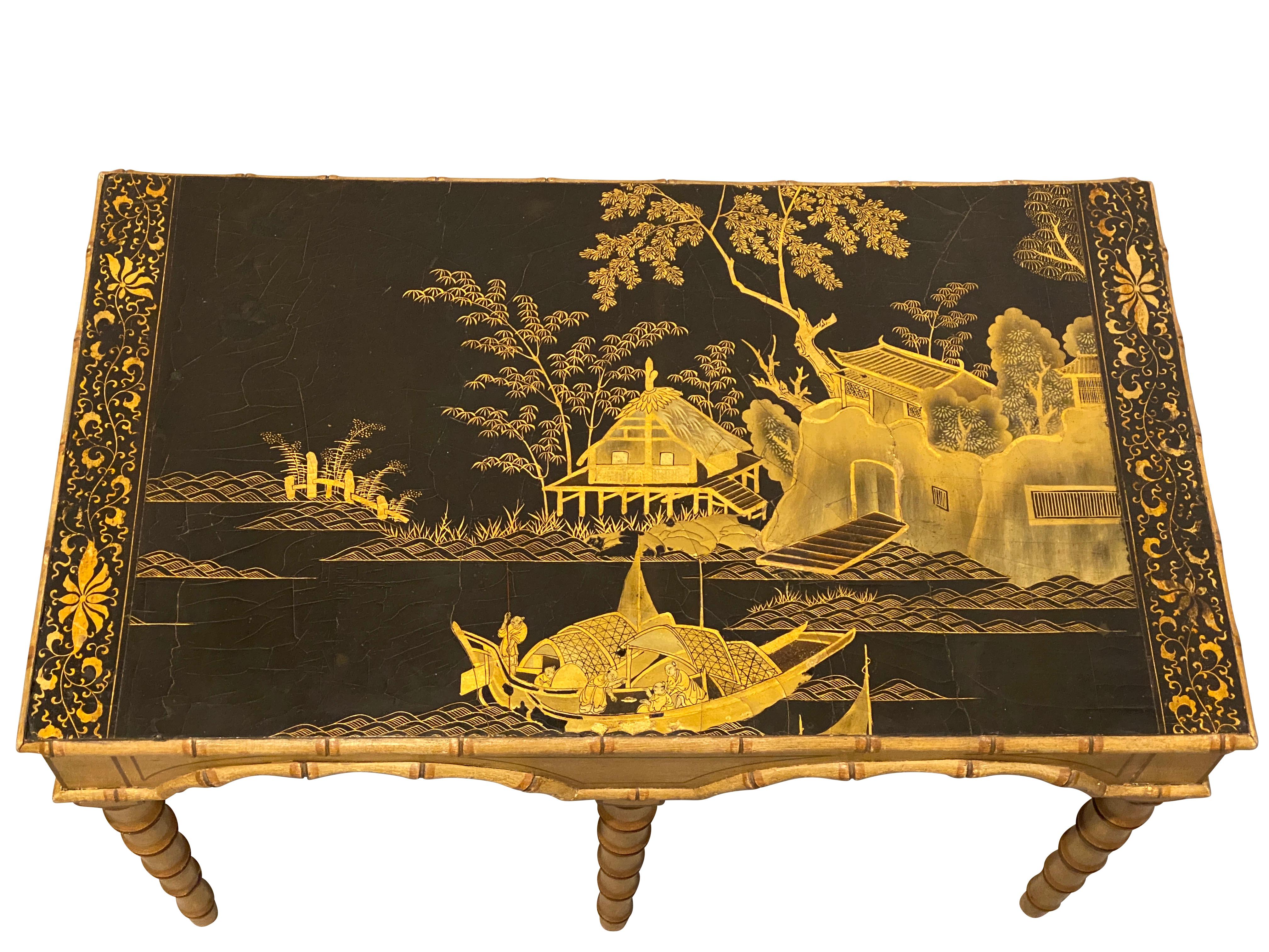 With an old Canton black and gold lacquer top set in a painted faux bamboo frame, faux bamboo straight legs.