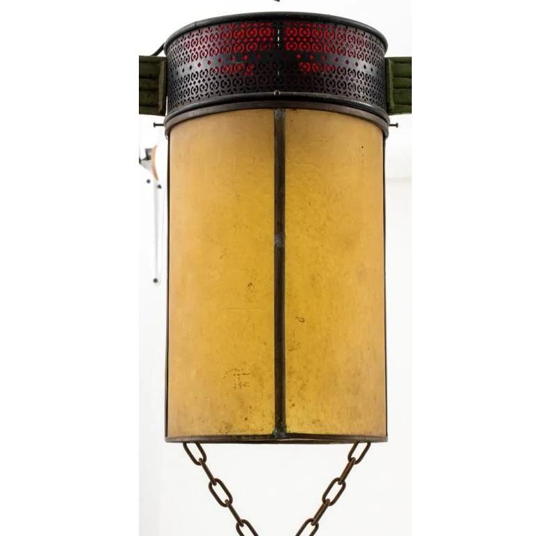 Chinoiserie art deco period polychromed wrought iron pendant chandelier lantern, the canopy issuing an abstracted calligraphic form holding two chains from which are suspended a columnar lantern with an ornamental band issuing green-painted dragon