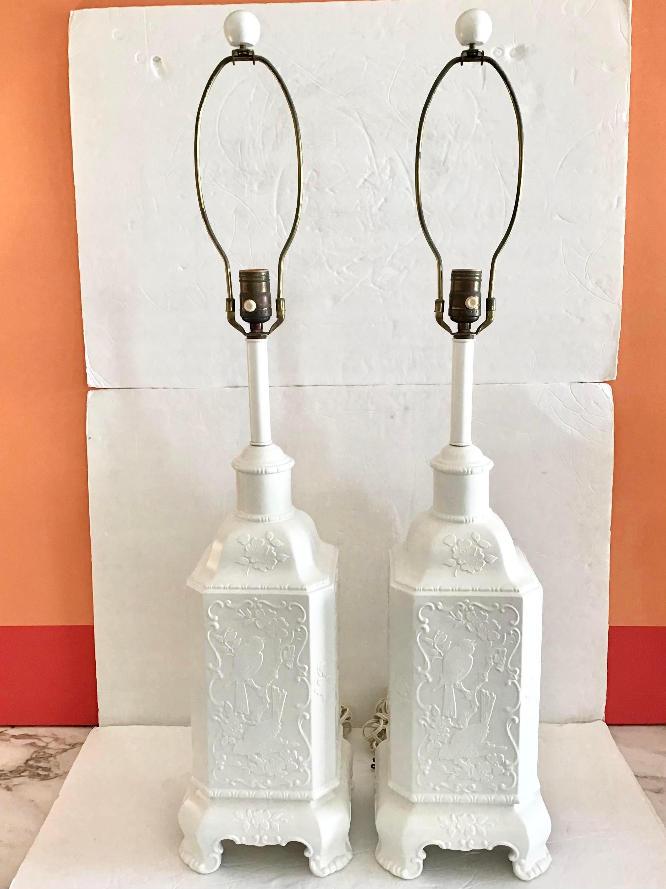 Fabulous pair of freshly lacquered in white rectangular Asian chinoiserie ceramic table lamps. Nice flora and fauna motifs on the sides. Add this pair to your boho chic inspired interiors. Does not include shades so add a pair of your choice.