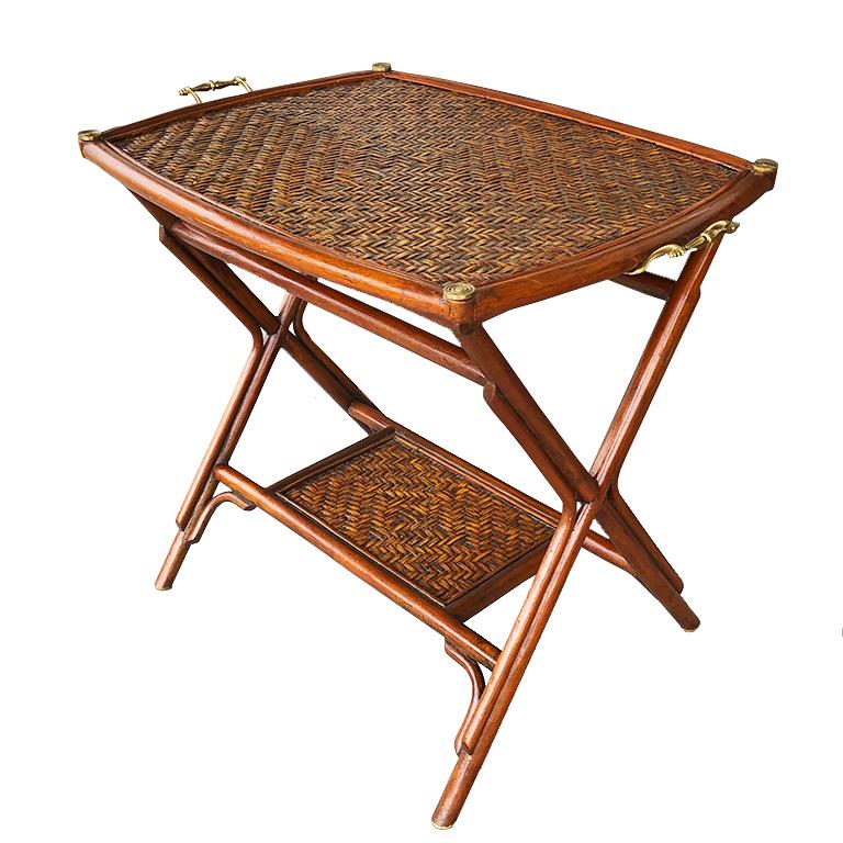 Authentic 1970's Bamboo, cane and brass two-tier butler or occasional tray table or nightstand. Made in the 1970s from the Philippines by Maitland Smith. This beautiful bamboo tray table includes 2 tiers, all with brass details. The top portion is