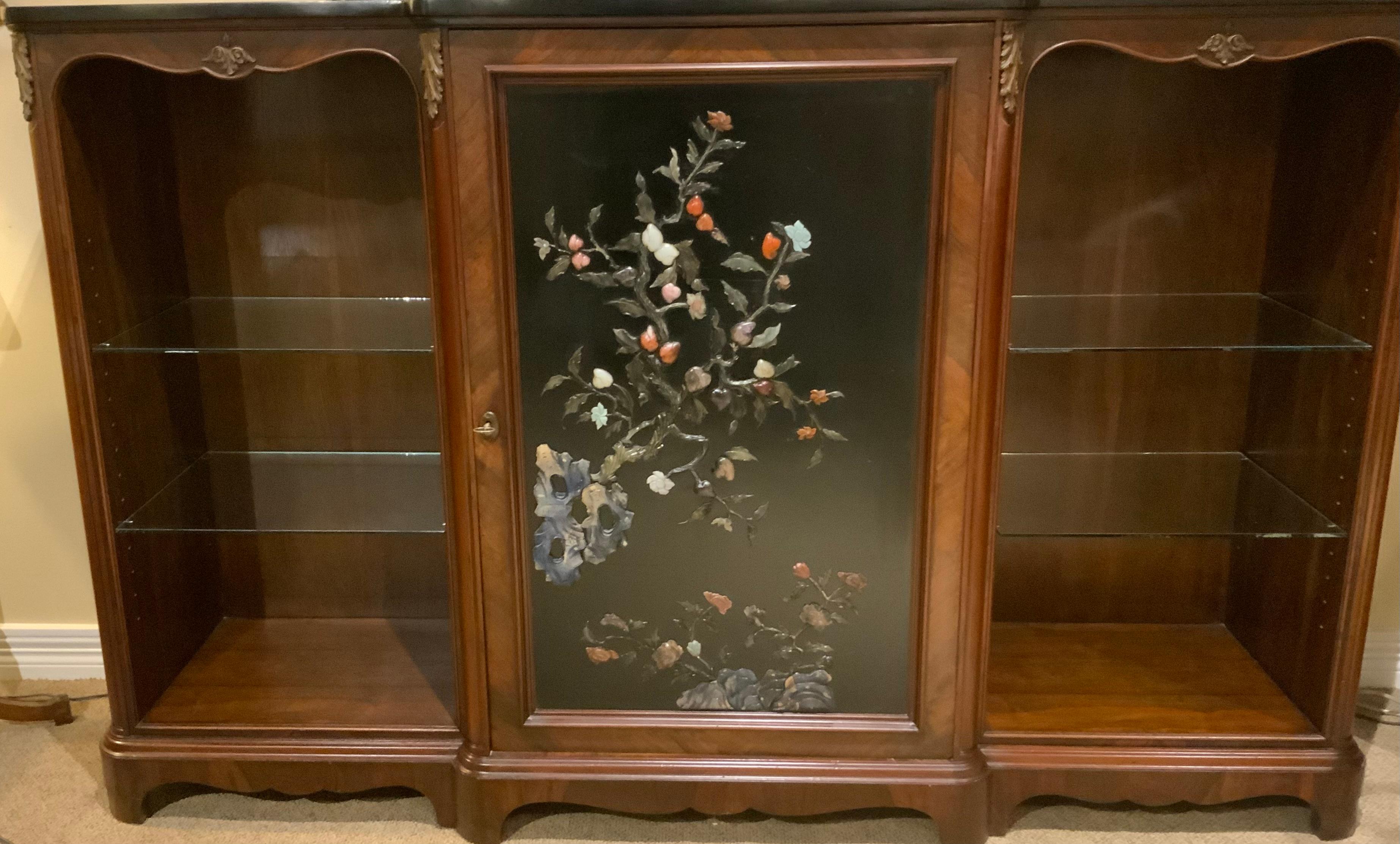 This special and rare cabinet was made in France of fine
Rosewood. The central panel is a door which opens to
A mirrored interior with two glass shelves, the front panel
Is decorated in a chinoiserie design depicting a foliate
Pattern of leaves and