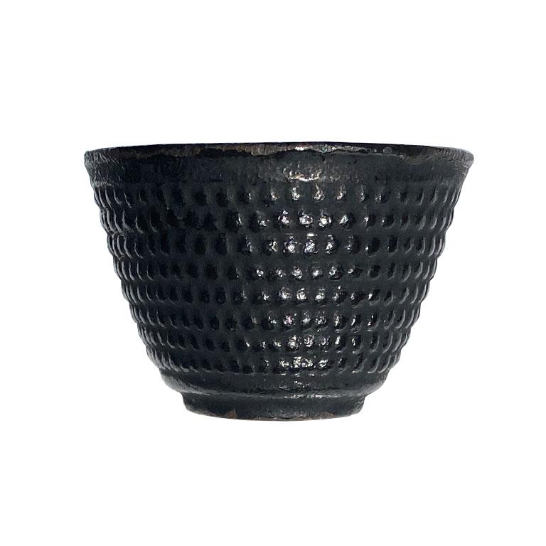 A pair of two black iron Chinese teacups with a raised knobby pattern around the body. 

Dimensions:
2.75