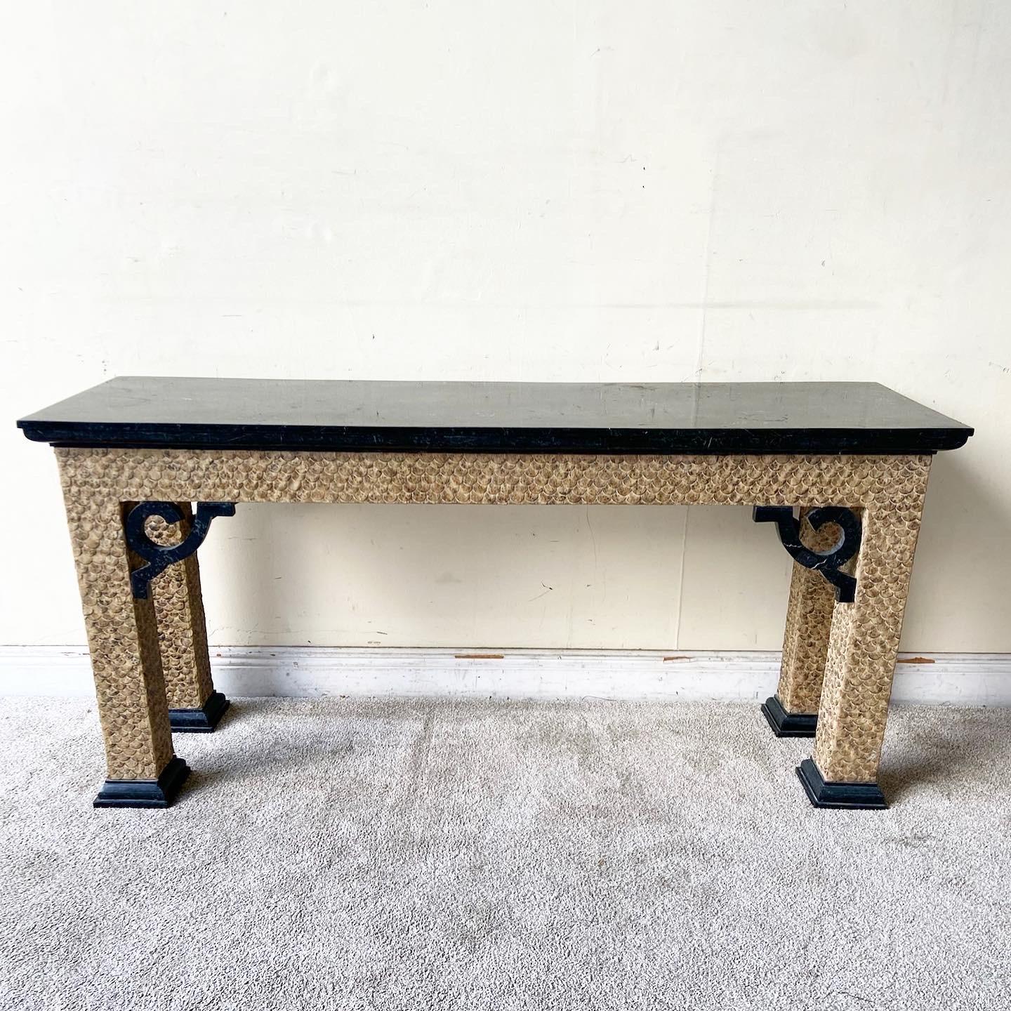 Exceptional vintage chinoiserie console table. Features a tessellated black stone top with a carved wooden frame.
 