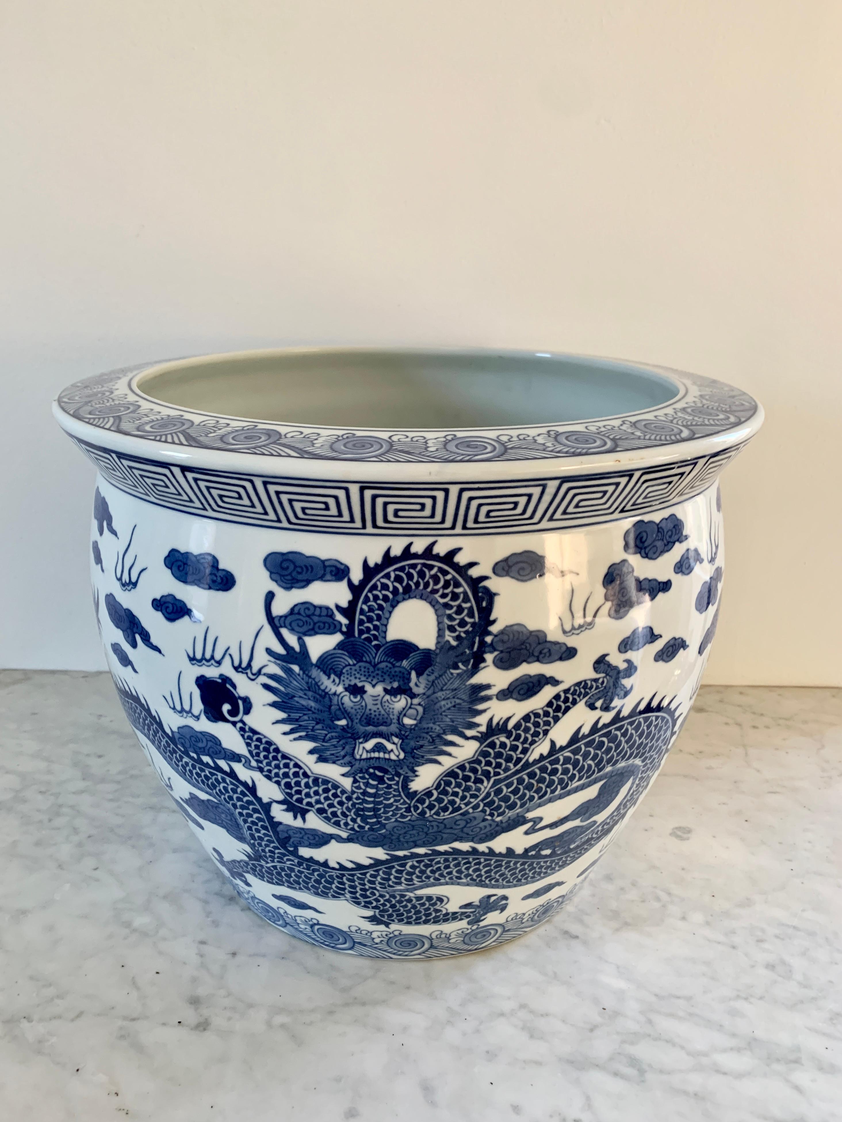 A gorgeous Chinoiserie blue and white porcelain fishbowl planter featuring a Chinese dragon and a Greek key border

Circa late 20th century

Measures: 14.25