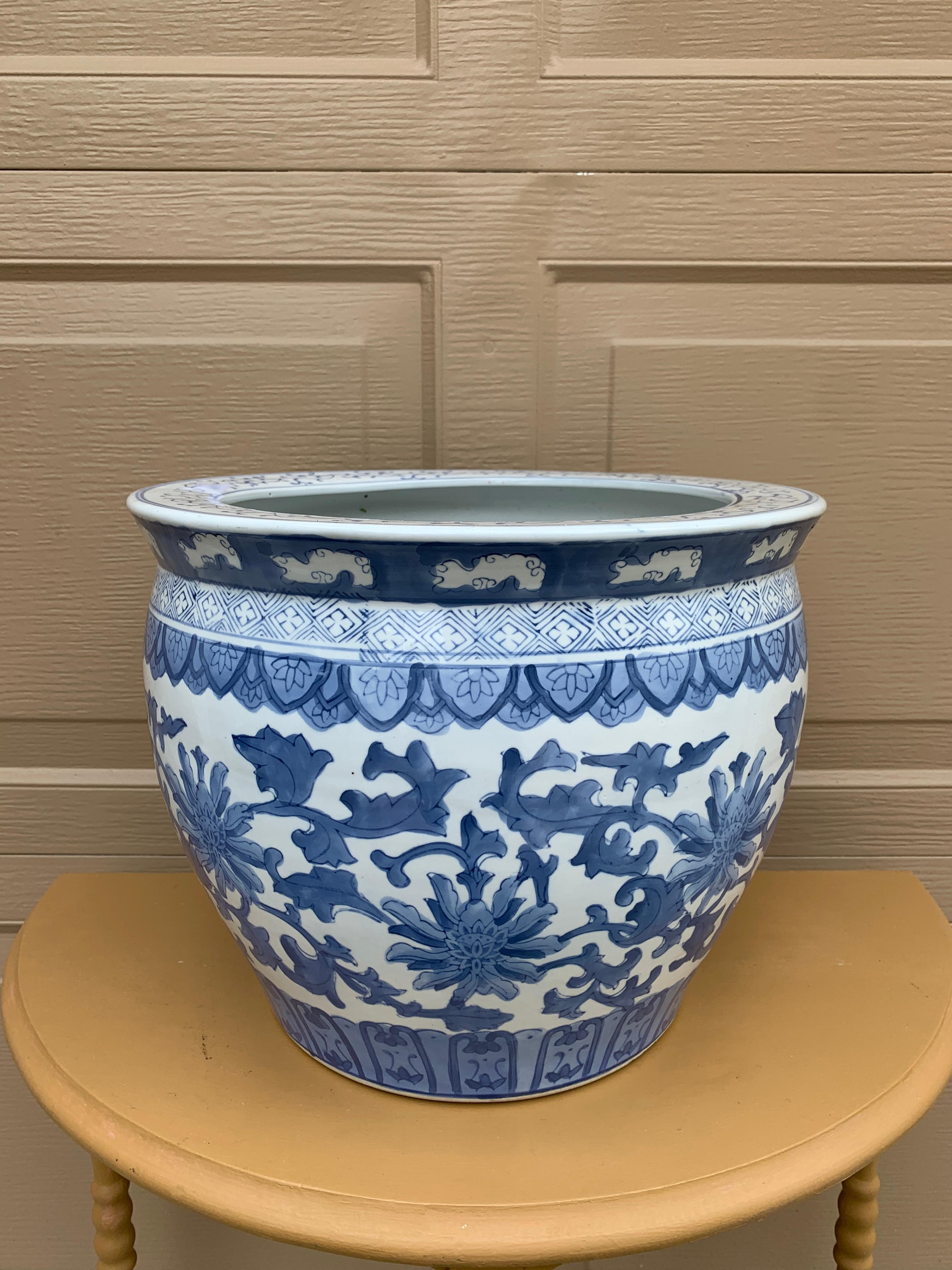 A gorgeous Chinoiserie blue and white porcelain fishbowl planter featuring Asian floral designs

China, Late 20th Century

Measures: 13.38