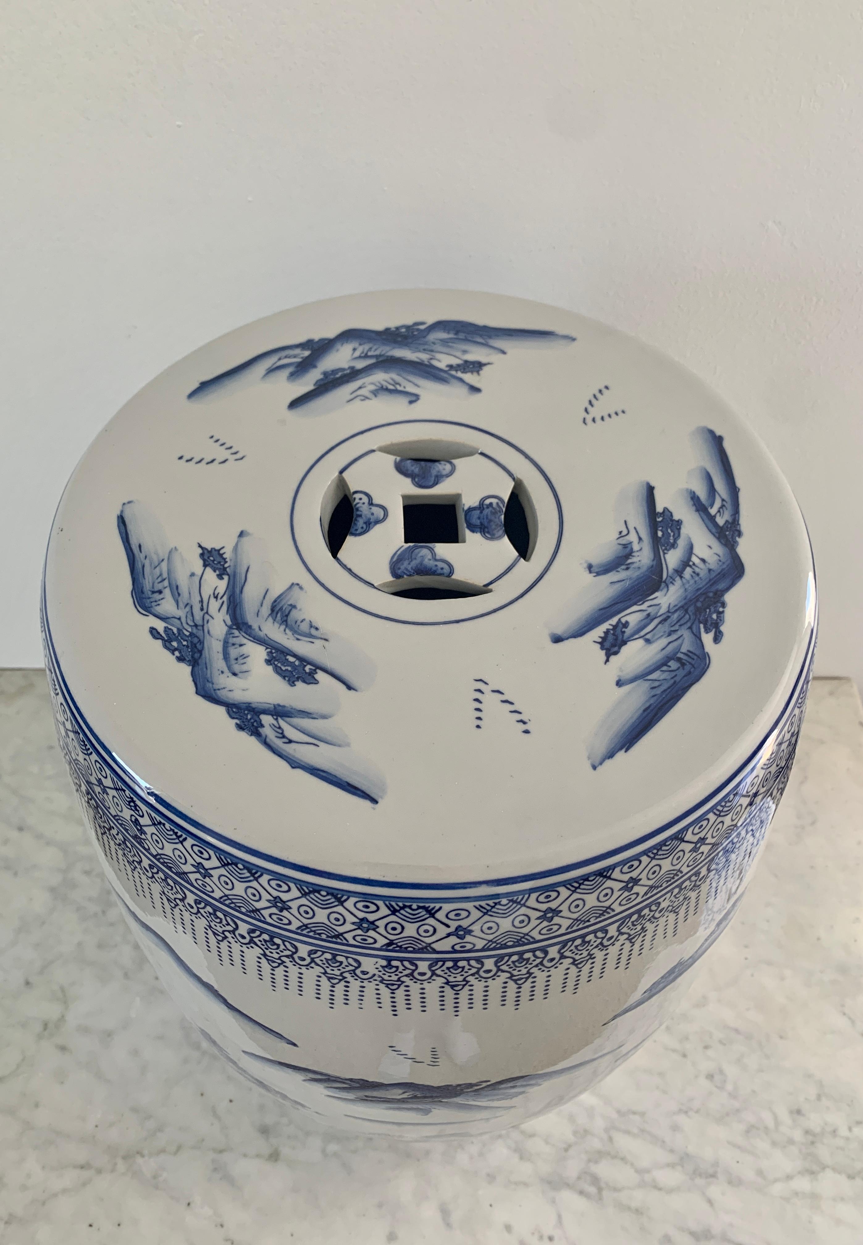 A gorgeous Chinoiserie blue and white porcelain garden stool, plant stand, or small side table featuring depictions of a scenic Asian landscapes and floral borders. 

China, Late 20th Century

Measures: 13