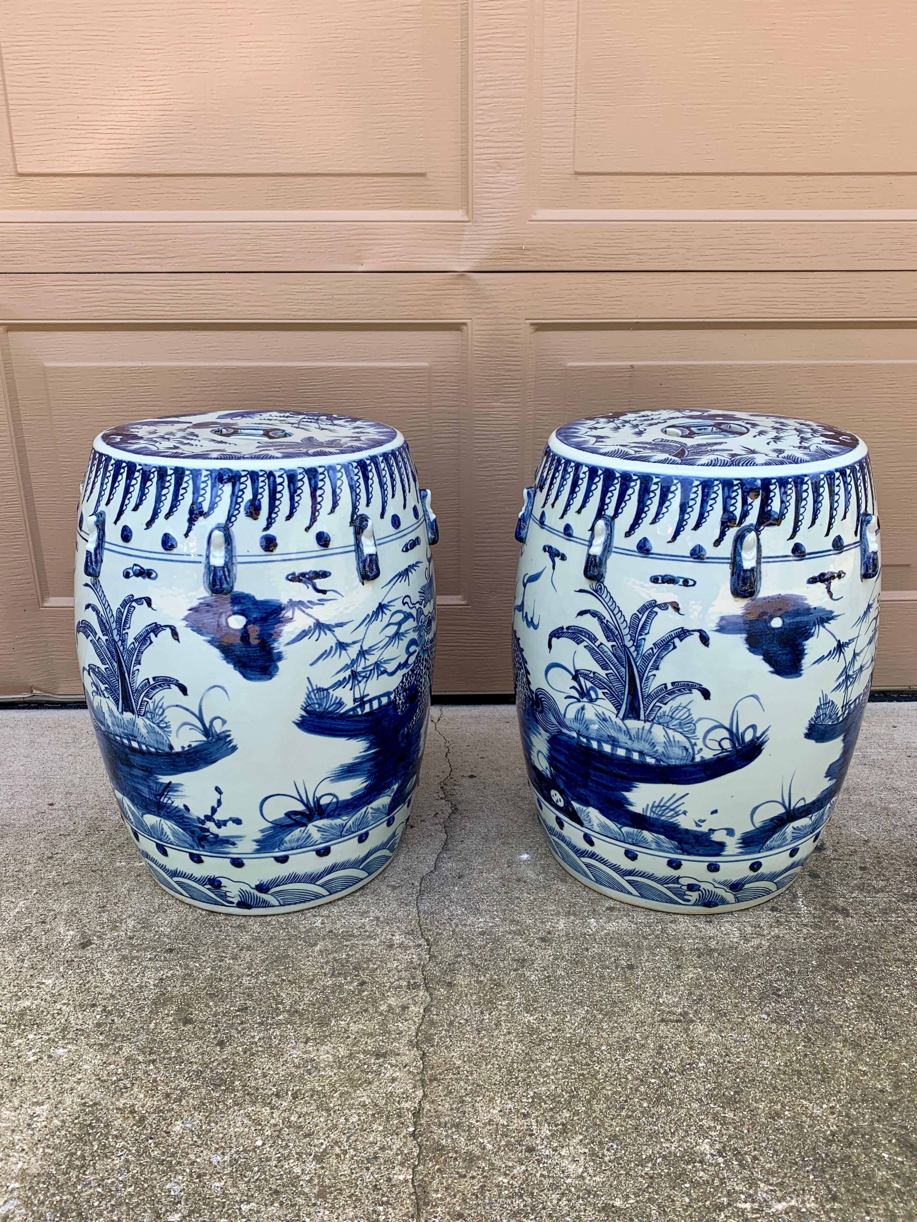 A gorgeous pair of Chinoiserie blue and white porcelain garden stools, plant stands, or small side tables featuring depictions of a scenic Asian landscape and dragon.

China, Late 20th Century

Measures: 14.5