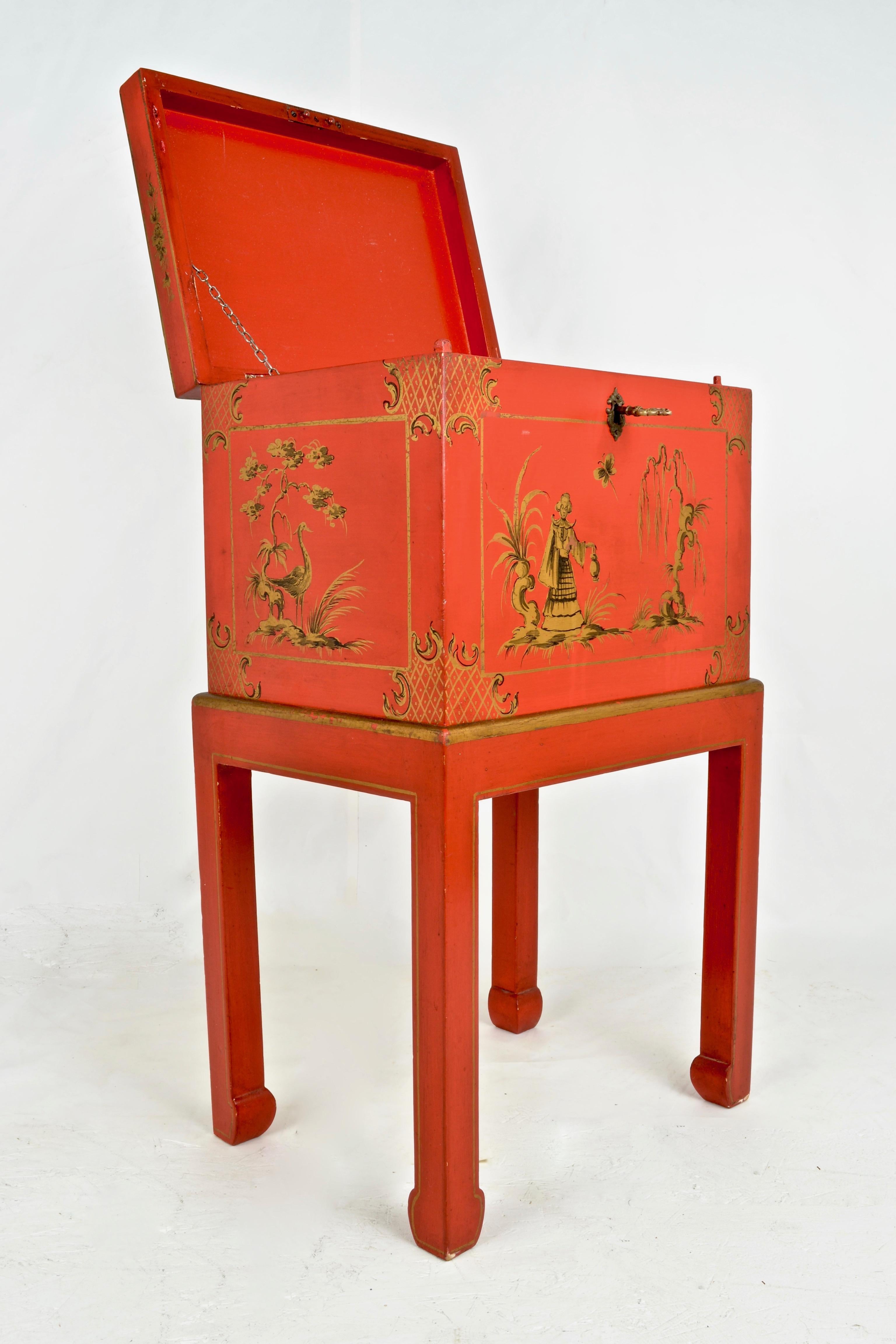 Wonderful color! Featuring hand painted gold decoration and figured brass key, this lidded box on stand has lots of charm. The box lifts off the custom stand. Interior in matching orange finish. Generally very fine condition with very little wear.