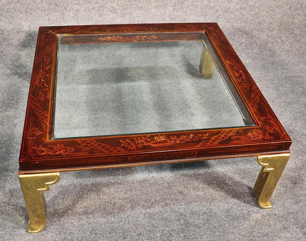 This is a gorgeous Mastercraft (attributed) coffee table, featuring gorgeous chinoiserie hand painted scenery and beautiful solid brass legs. The beveled glass top adds more glamour to the table.