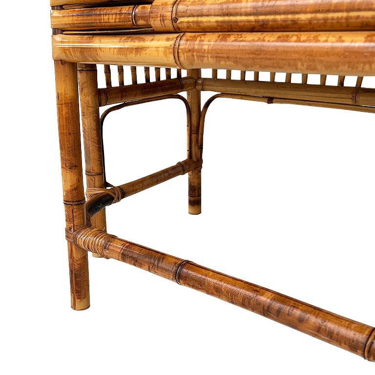 An early burnt bamboo and cane chinoiserie Brighton Pavillion armchair, bench, or settee with woven cane seat. A rare find, this timeless long armchair has a split frame and long upright back. It features intricate inset geometric and foliate bamboo