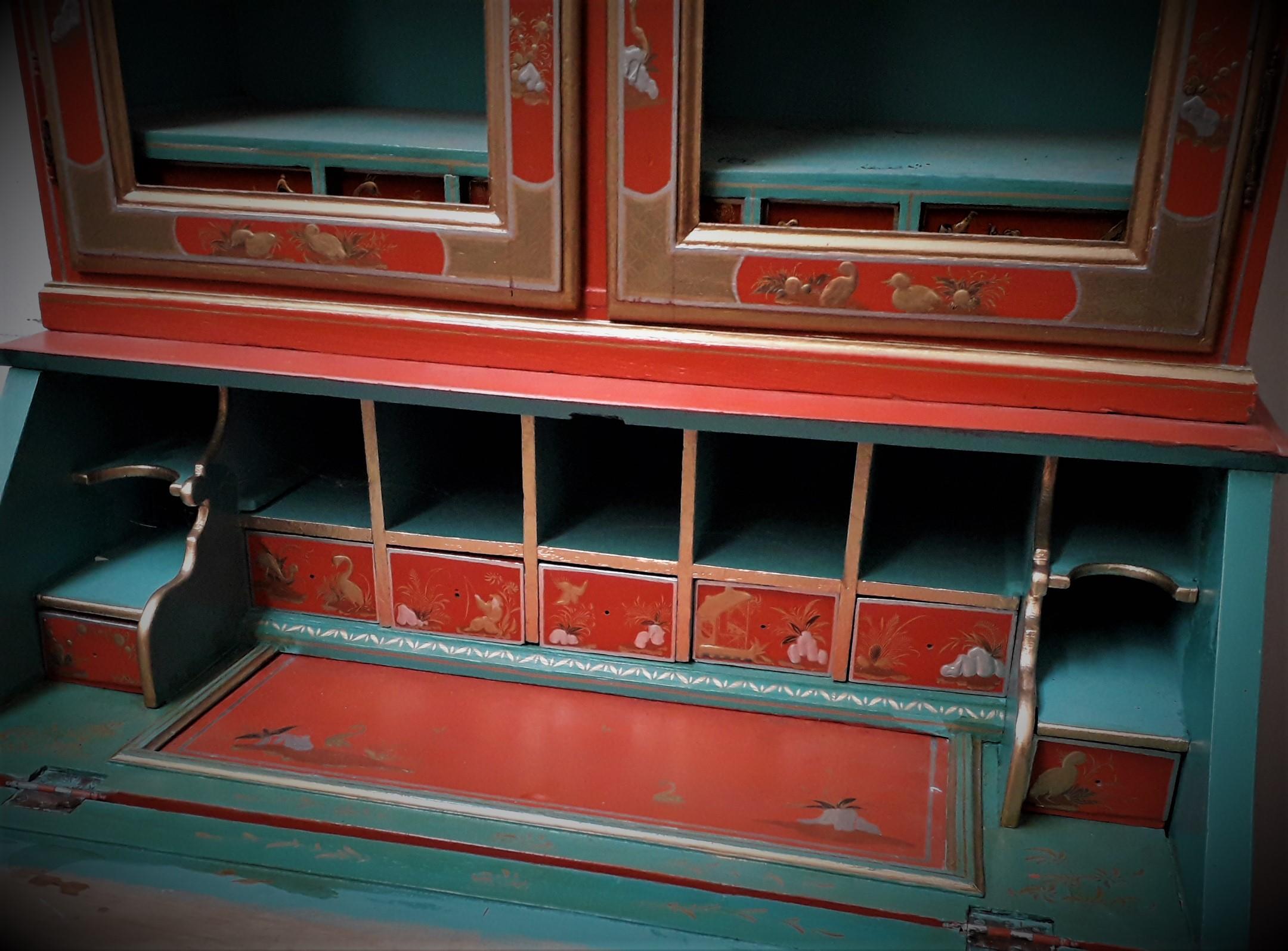 Chinoiserie Red Lacquer Bureau Bookcase.

The shelved upper part with double broken arched doors opening to reveal a part fitted interior with lower small drawers, more Chinoiserie scenes decorate the fitted bureau interior with a slide top hidden