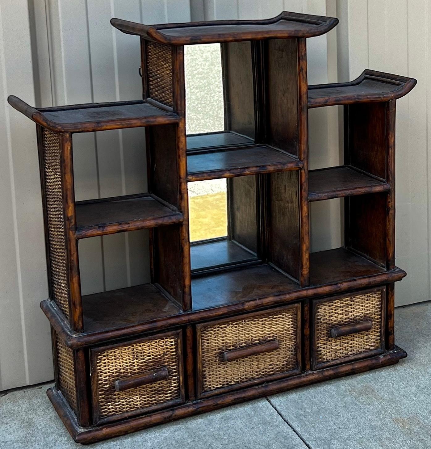 This is a such a nice little set. It includes a burnt bamboo pagoda form wall shelf and a coordinating single door cabinet. 
The shelf measures 28.5”L x 8”W x 27”H. It has two mirrored sections.
Both are unmarked and in very good condition. 

My