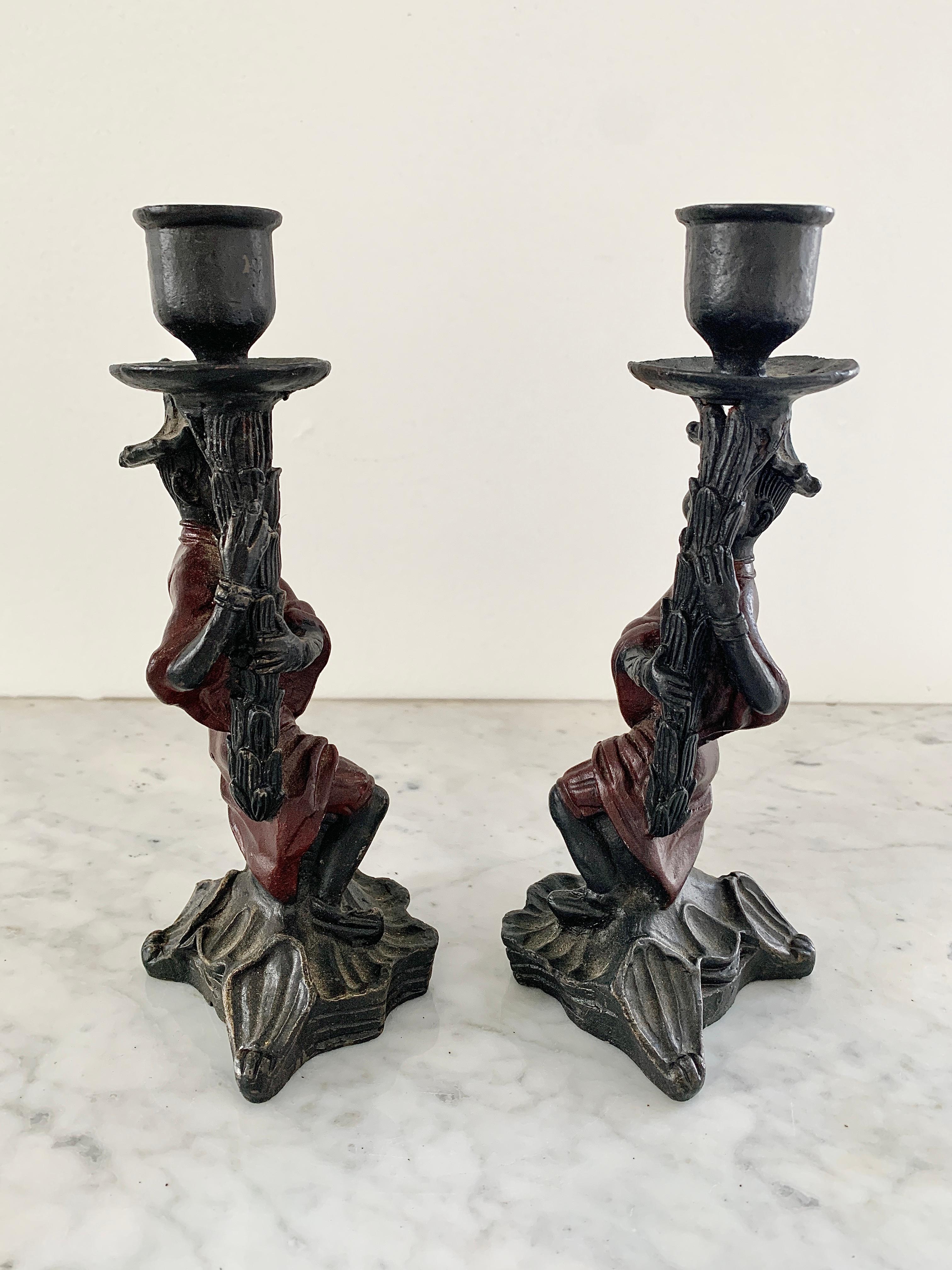 A wonderful pair of cast iron Chinoiserie candle holders.

20th Century

Measures: 3.75