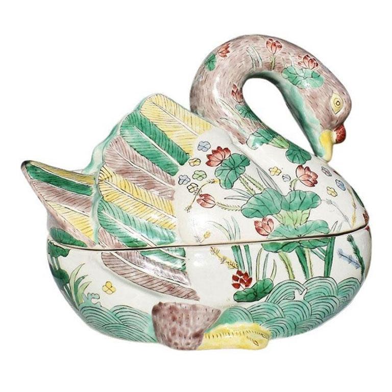 A petite ceramic famille verte duck tureen. Hand-painted in an array of greens, purples, blues, yellows, and reds, this lidded vessel will be a fabulous addition to your next dinner party. Formed in the shape of a duck, the top is removable to