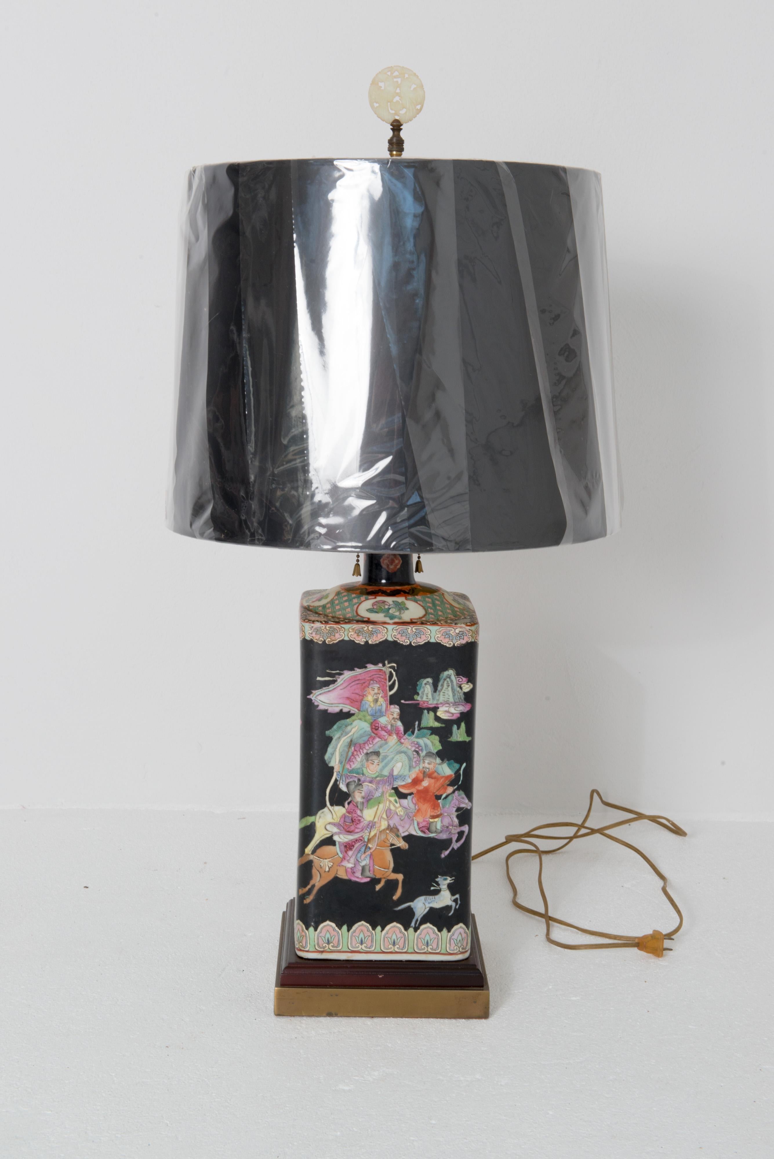 Good looking rectangular Asian black ceramic lamp. The background is black with beautiful scenic animals and figures in mint green, pinks, and tangerine. Height listed is to the top of the new paper shade. Height to the top of the ceramic vessel is