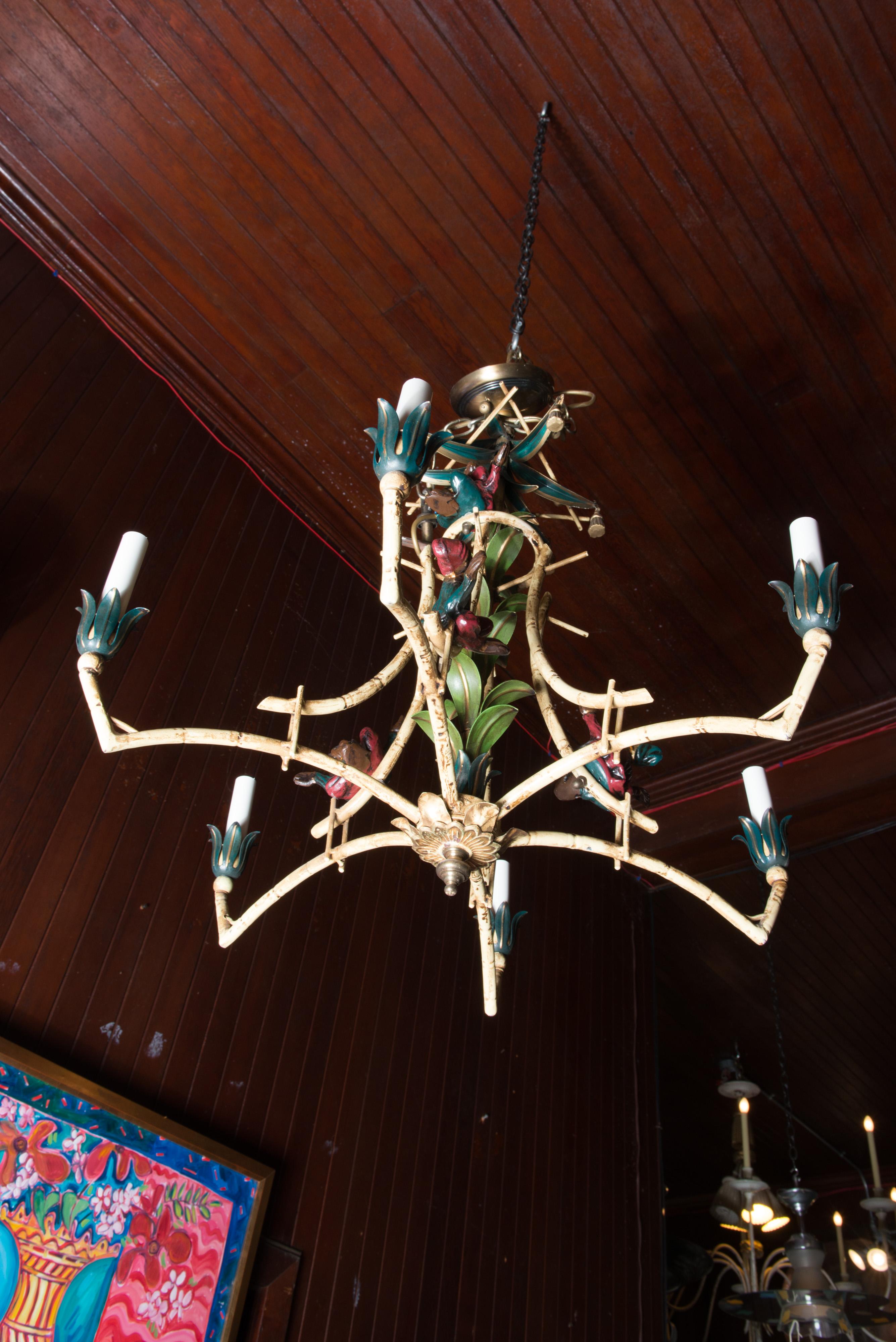 Painted iron Chinoiserie chandelier with decked out monkeys, tassels, and balls. Canopy and chain included.
Accommodates six chandelier bulbs.
