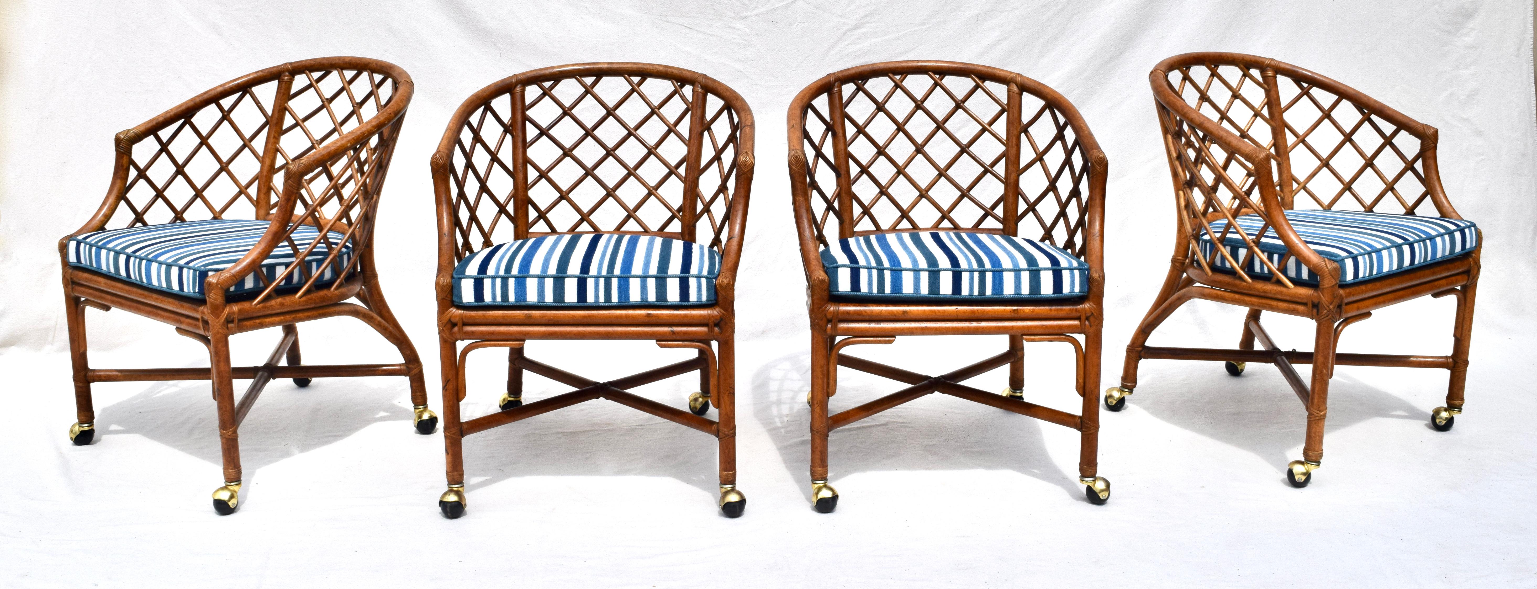 A pair of bent bamboo Chinese Chippendale barrel chairs on brass casters attributed to Ficks Reed. Lovely caned seats are enhanced with new cushions rich in various blues of chenille velvet with white and blue linen upholstery. Two pairs are