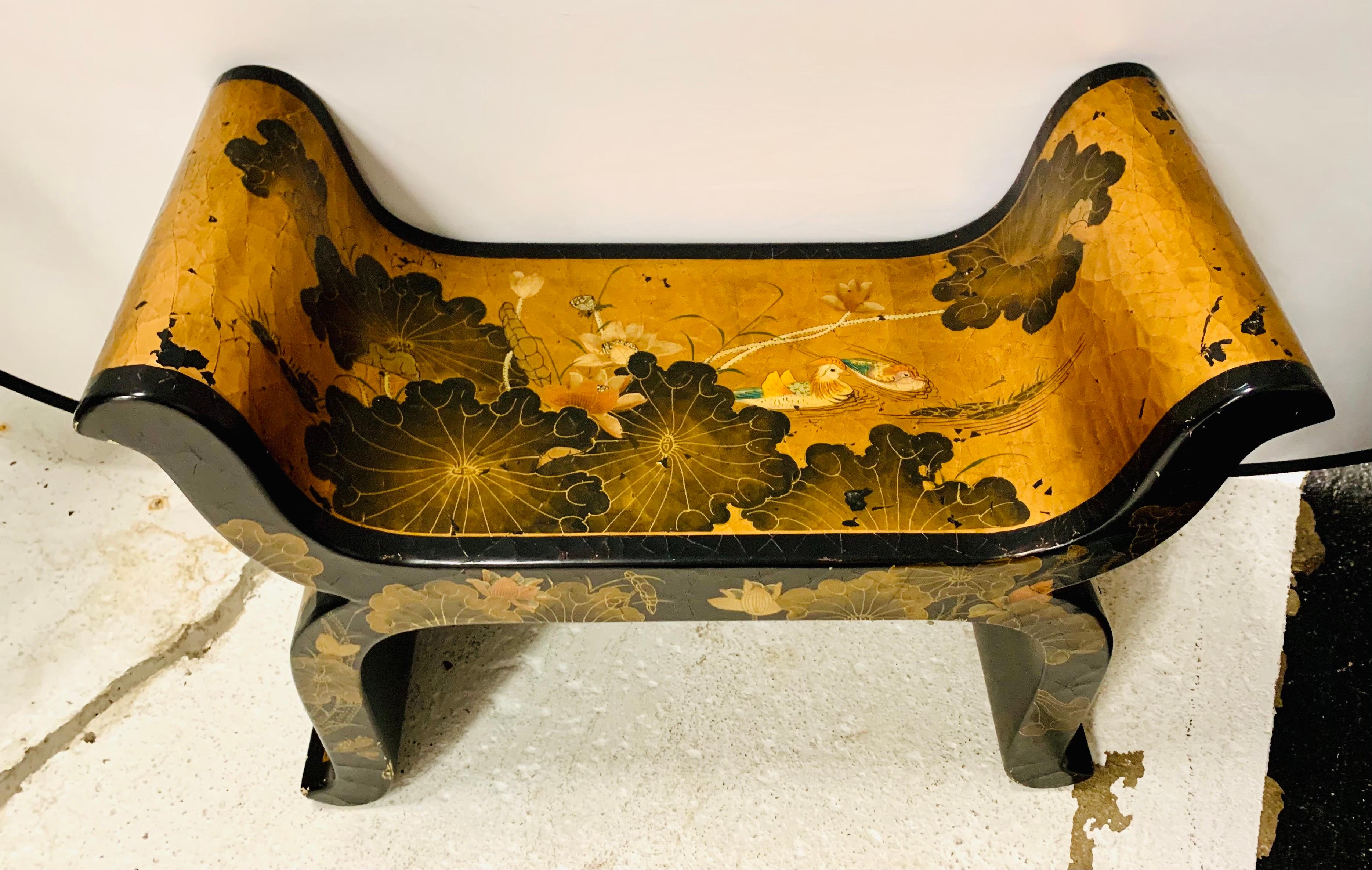 Exquisite Chinoiserie black lacquer bench with beautiful hand painted pond scenery of water lilies and ducks all on a gold leaf background.
