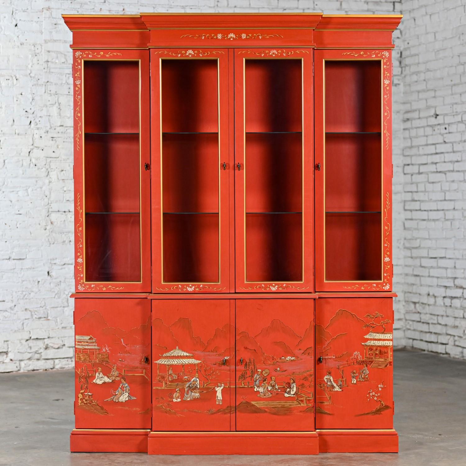 Gorgeous vintage Chinoiserie Chinese red breakfront lighted China hutch, bookcase, or display cabinet comprised of two sections including a lighted top hutch with glass inset door fronts, brass pulls, glass shelves with plate grooves, and hand