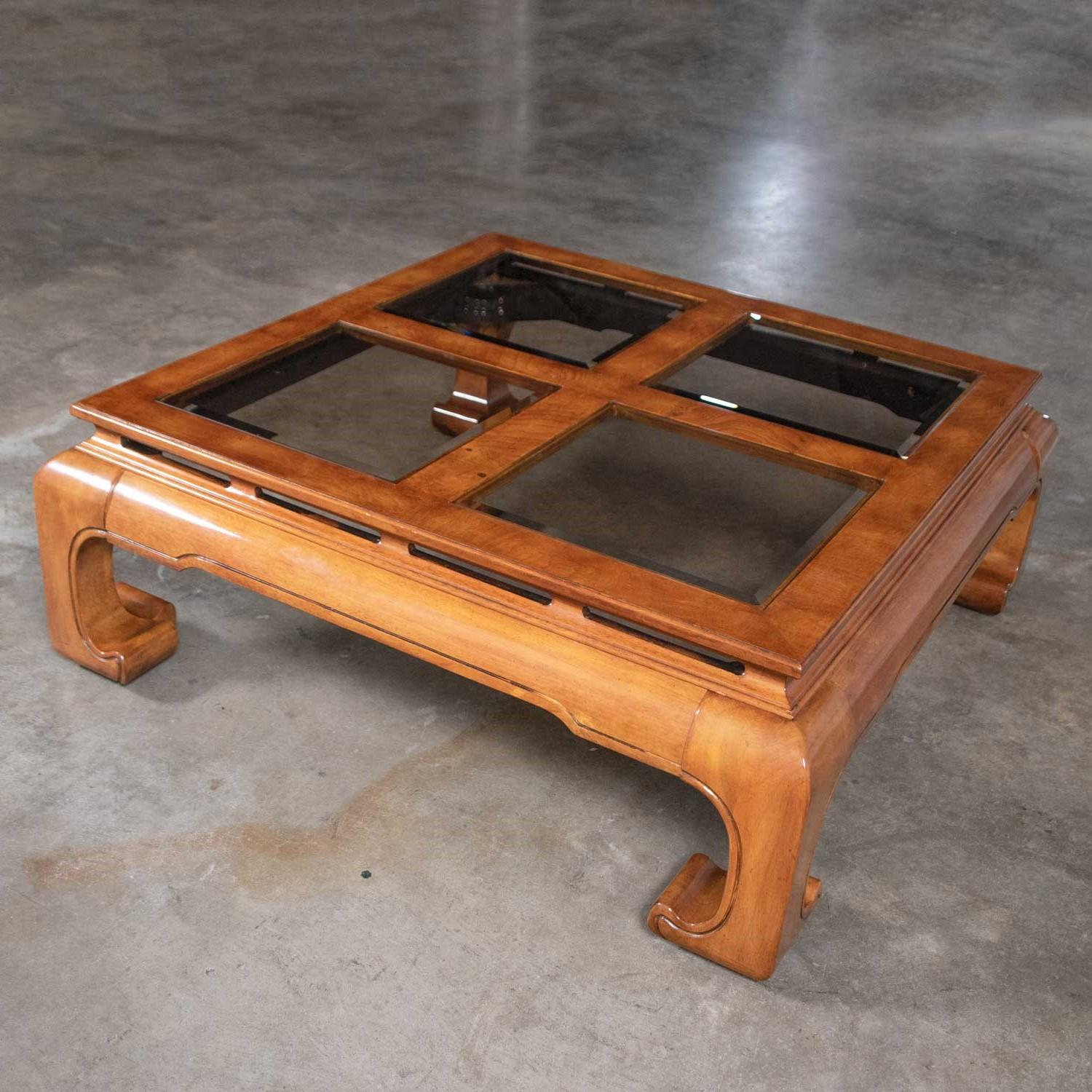 Fabulous chinoiserie chow leg Ming style large square coffee table with four beveled smoke glass inserts in a burl wood veneer frame. Attributed to Schnadig International Furniture. In wonderful vintage condition with only age appropriate wear and
