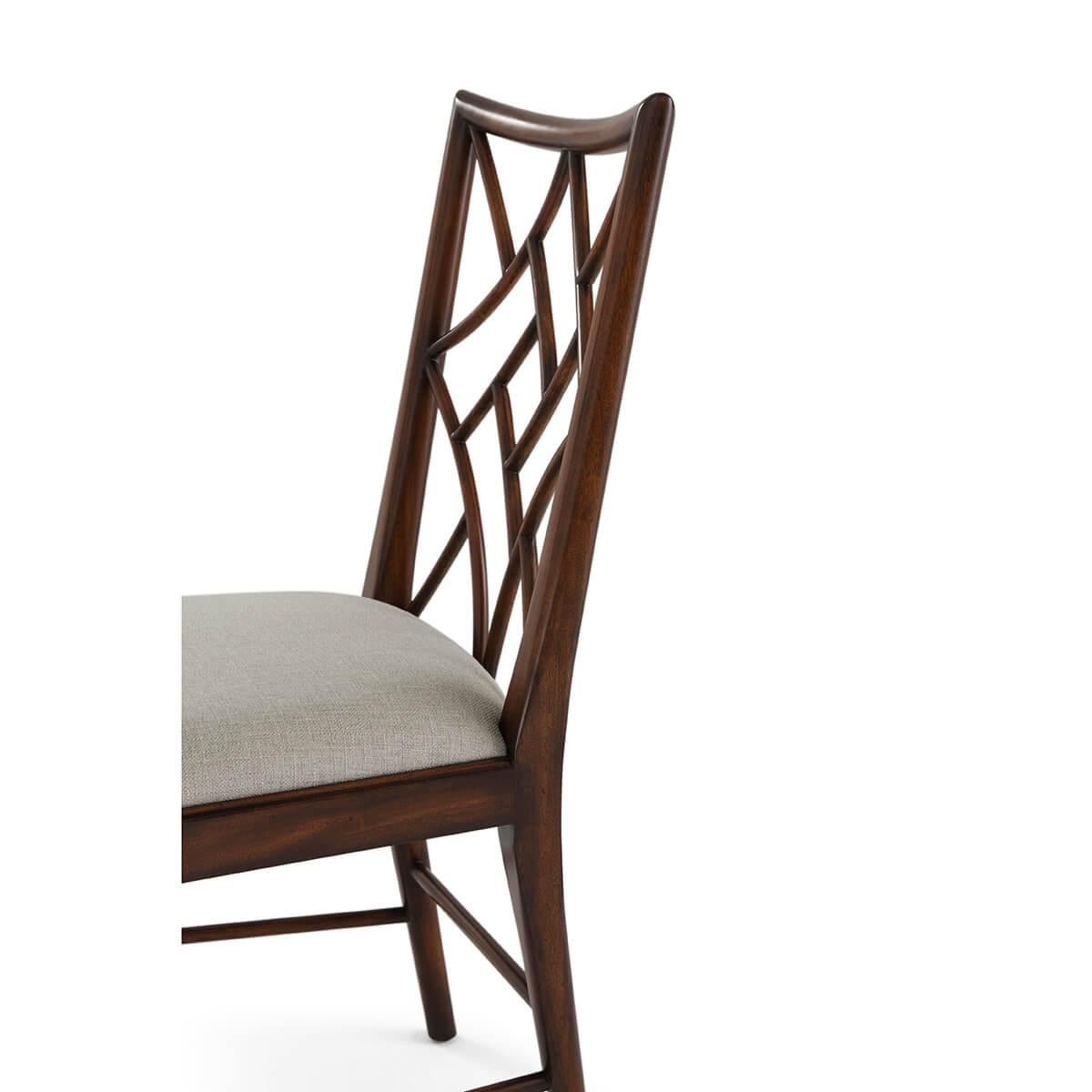 Featuring an intricate openwork lattice back, they honor the classic Chippendale style with graceful lines and exquisite detail. A solid wood frame with a rich stain and subtly curved tapered legs enhances their poised silhouette. The cushioned