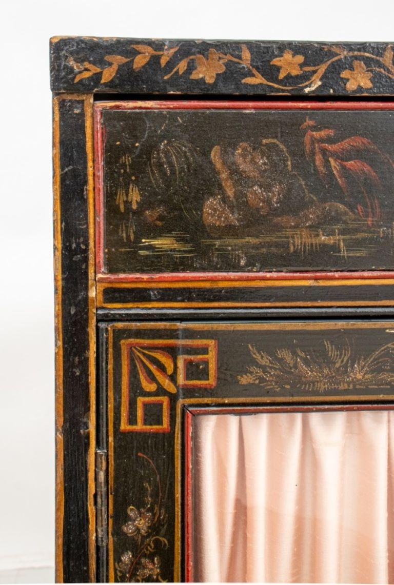 Chinoiserie Decorated Black Lacquer Cabinet, rectangular,  the painted stop with geometric Chinoiserie fretwork border, above two short drawers and two glazed cabinet drawers, the sides decorated with gilt scenes.

Dealer: S138XX