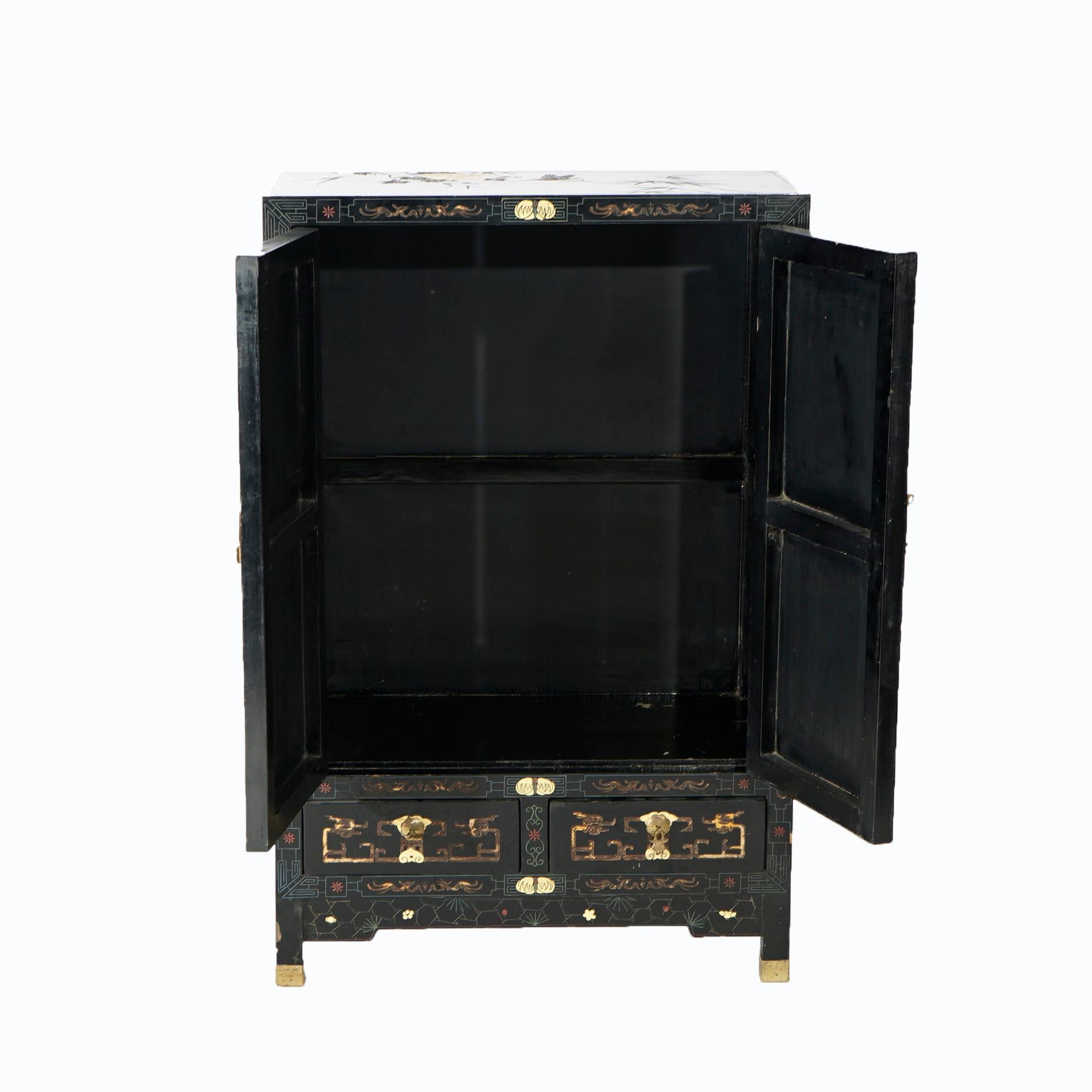 A cabinet offers black lacquered wood construction with Chinoiserie decoration including figures having spiritual experience and garden elements, double door cabinet over two drawers as photographed, 20th century.

Measures- 40''H x 26''W x