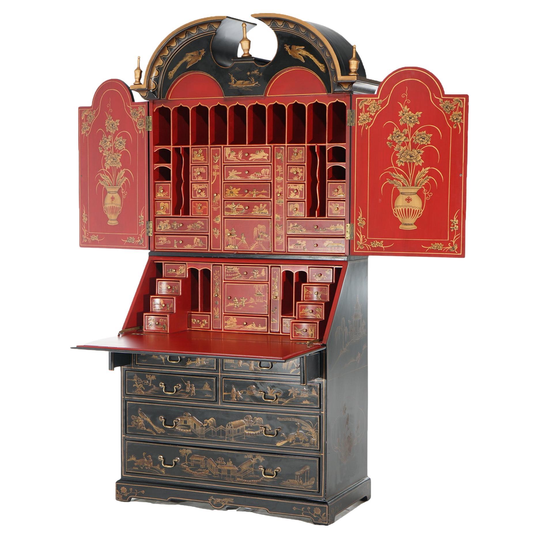 A Chinoiserie decorated secretary offers black lacquered wood construction with upper having a broken arch pediment over a cast with double doors opening to vermillion red lacquered interior having gilt decoration and with storage drawers and pigeon