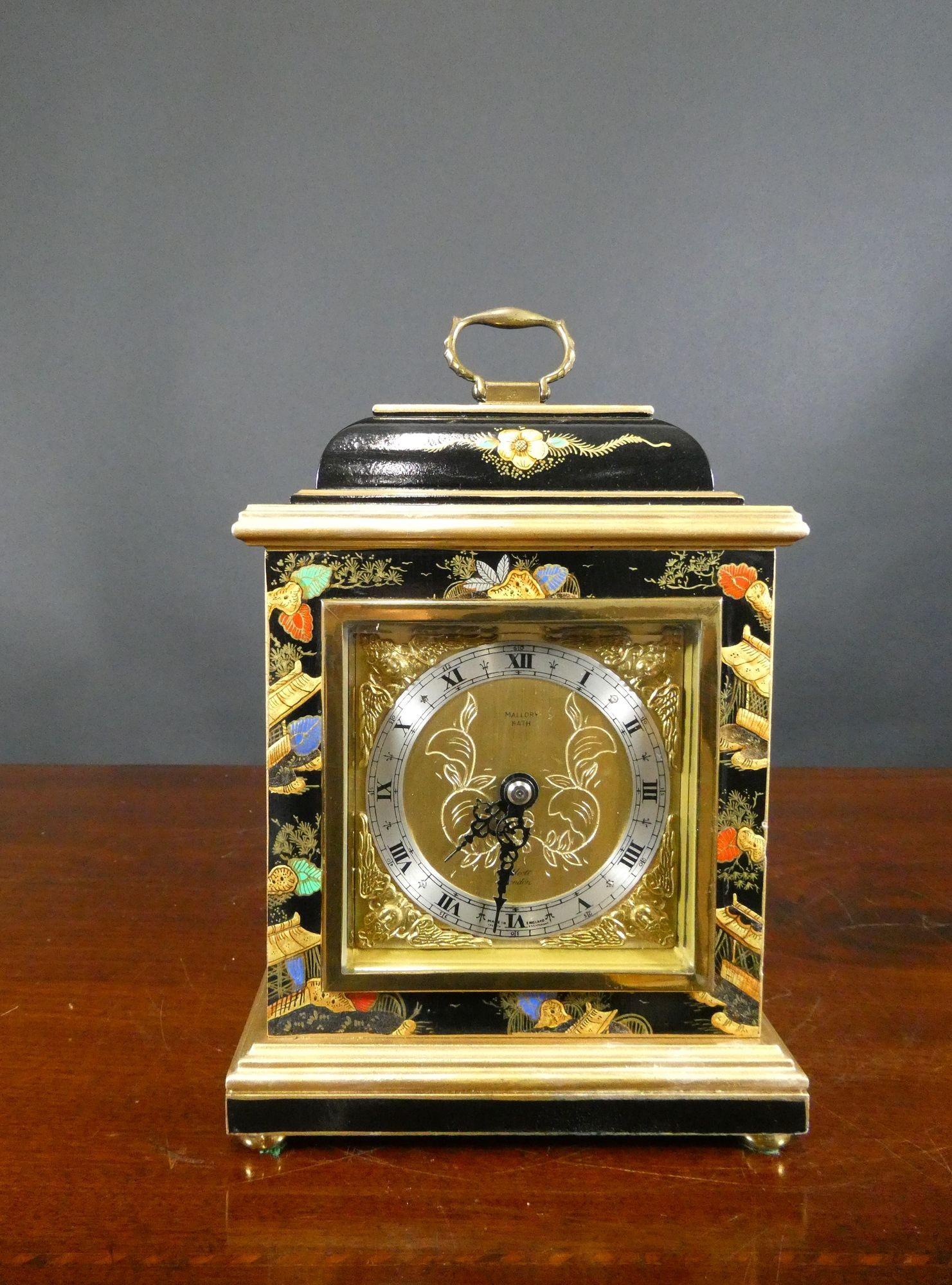 Chinoiserie Decorated Bell Top Mantel Clock by Elliott

Finely decorated bell top case with raised chinoiserie decoration depicting typical Chinese scenes on a black ground with gilded stepped mouldings, brass bun feet and surmounted by a decorative