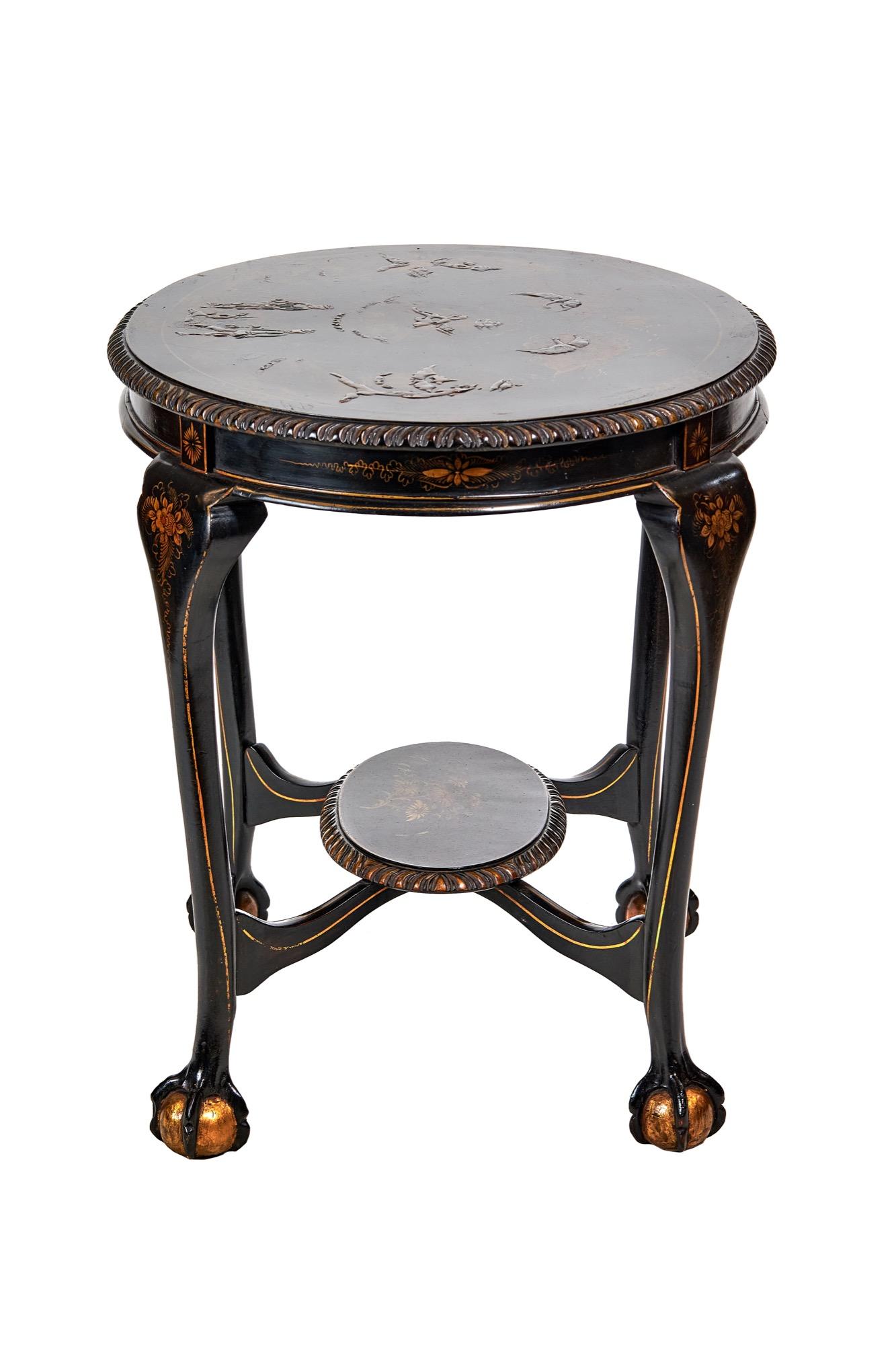 Chinoiserie Decorated Oval 2 tier table circa 1900.
Black & gilt Chinoiserie decoration, 
Top decorated with, figures, Houses, birds & foliage, &
Painted Diamond & gilt line detail, Gadrooned carved edge,
Oval under tier with floral decoration,