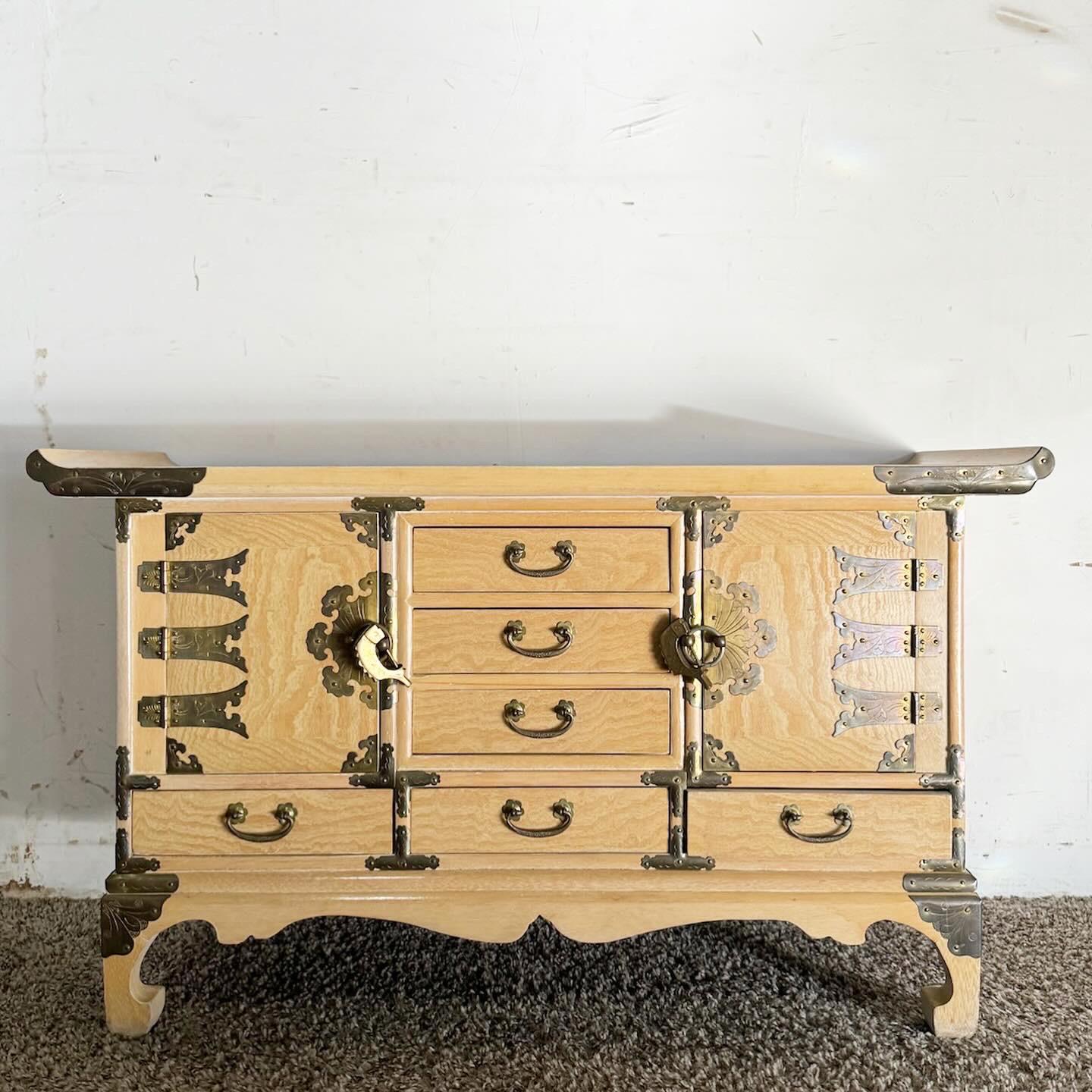 Experience the fusion of tradition and versatility with the Chinoiserie Elm High Point Altar Chest Sideboard. Crafted from durable elm wood and adorned with intricate Chinoiserie artistry, this multifunctional piece can be used as an altar, chest,