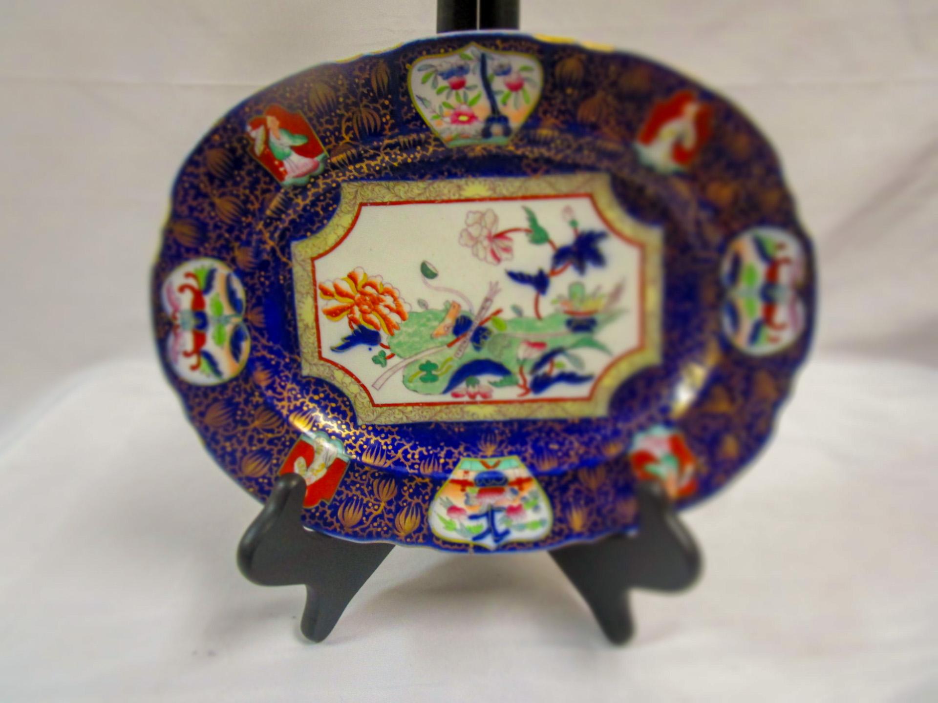 This very colorful cobalt blue, green and rust English Ironstone small platter is marked on the back with the royal crest and 