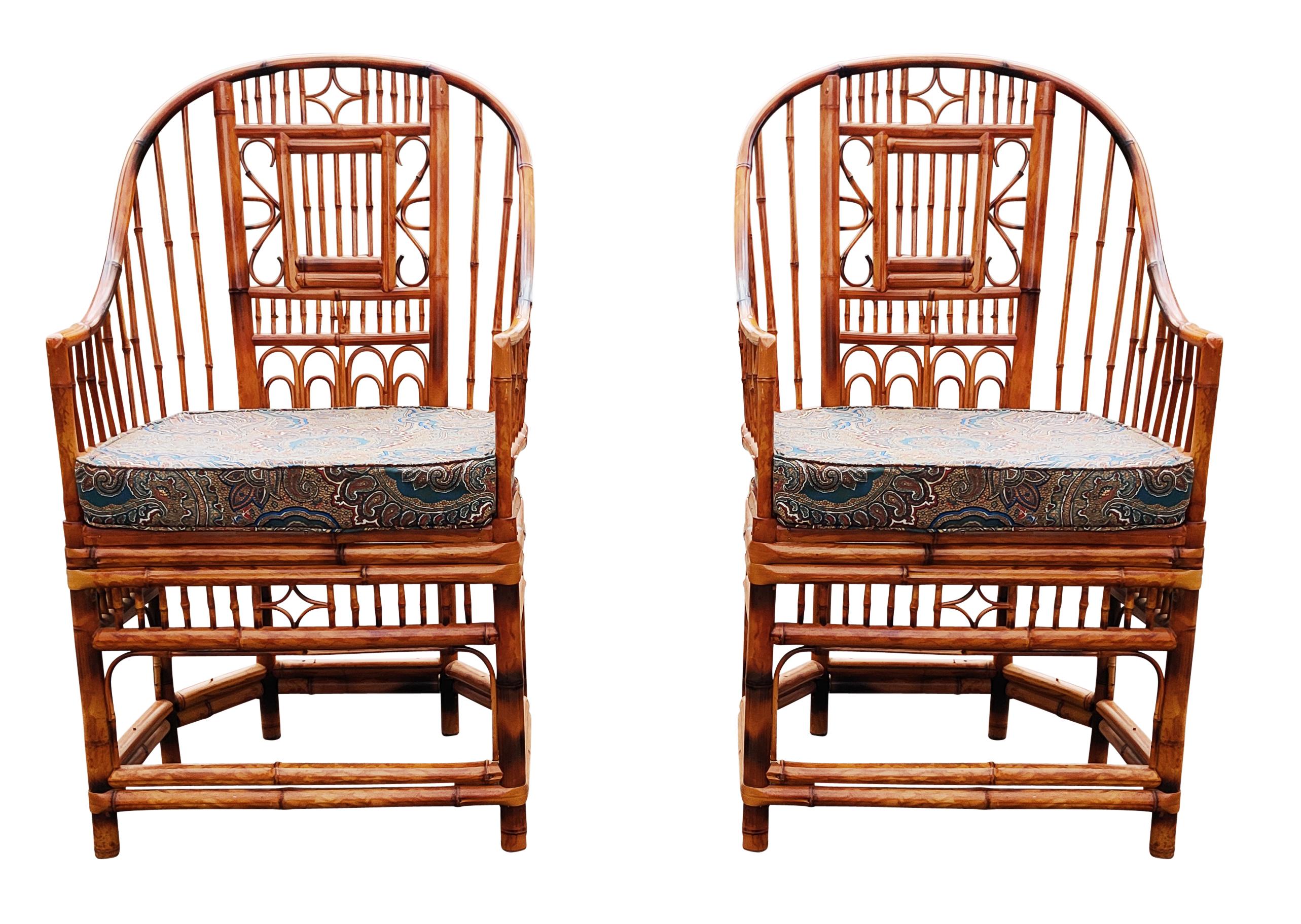 A apir chinoiserie bamboo and cane armchairs in the manner of Brighton Pavillion. A timeless design that has a split frame and upright back. They features intricate inset geometric and foliate bamboo openwork on each side, and smooth down swept