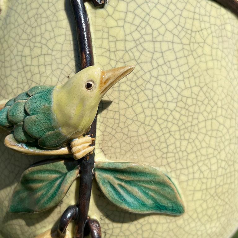 Sourced during a trip to Hong Kong, this large gorgeous bird motif vase will be the focal point in any room. It is created from a thick ceramic clay, and glazed in a yellow and gray craquelure. The body of the base is wide, and the neck is very