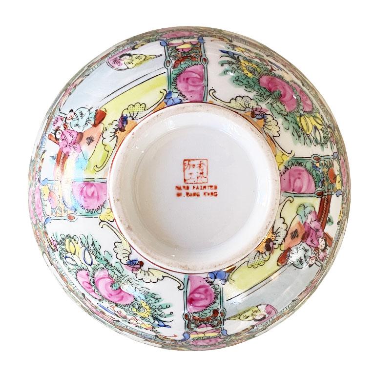 The true power of an object is the ability to tell a story. This is the reason we love this colorful Famille Rose chinoiserie ceramic bowl so much. Decorated in various hues of pink, yellow, green, blue, red and gold, it depicts the story of a woman