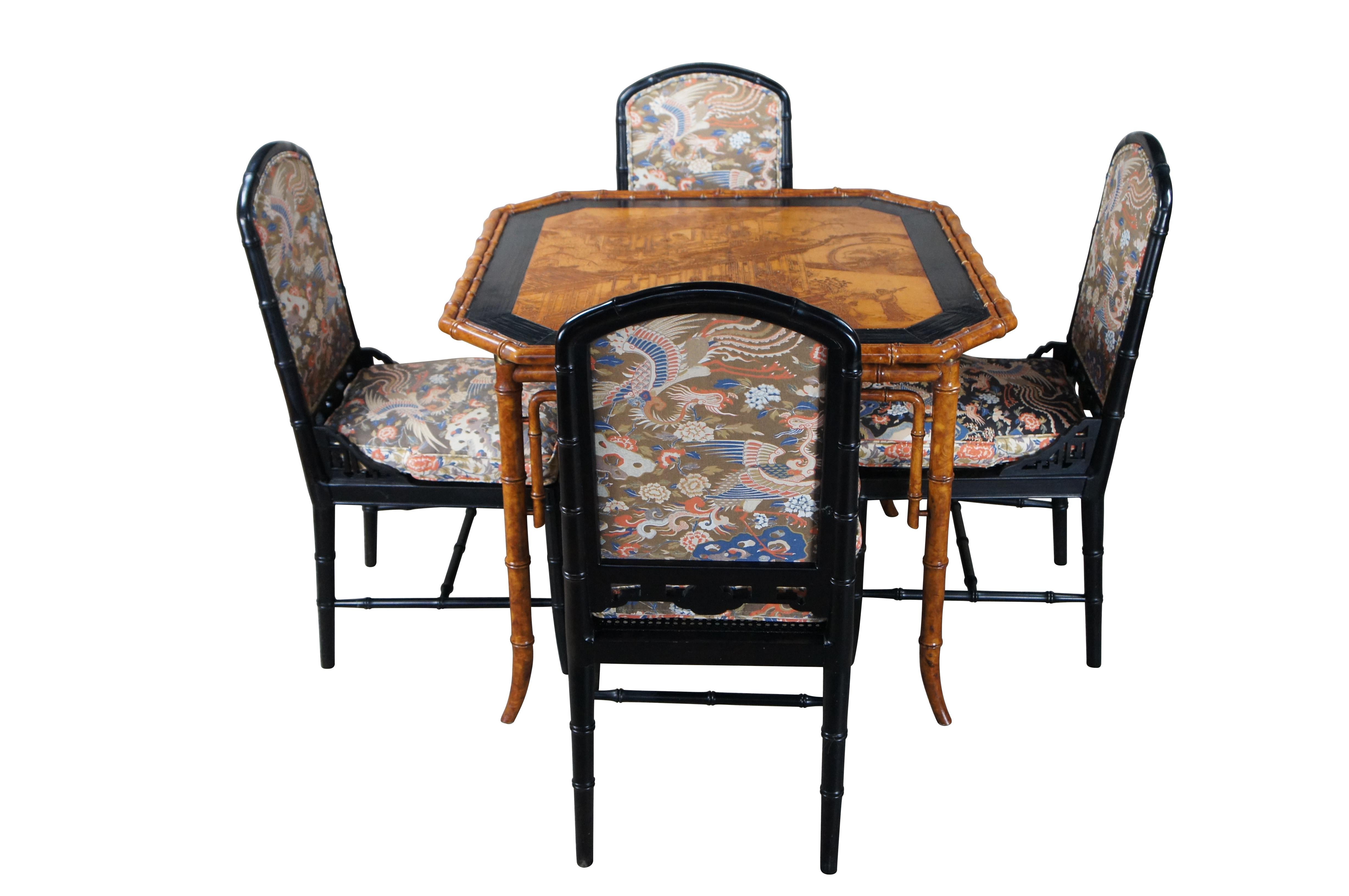Mid 20th century game or card table and four caned chairs featuring faux bamboo and black lacquered design.  The table top features a Japanese Geisha house with large mooongate and fold out trays for drinks or game pieces.  The chairs feature a