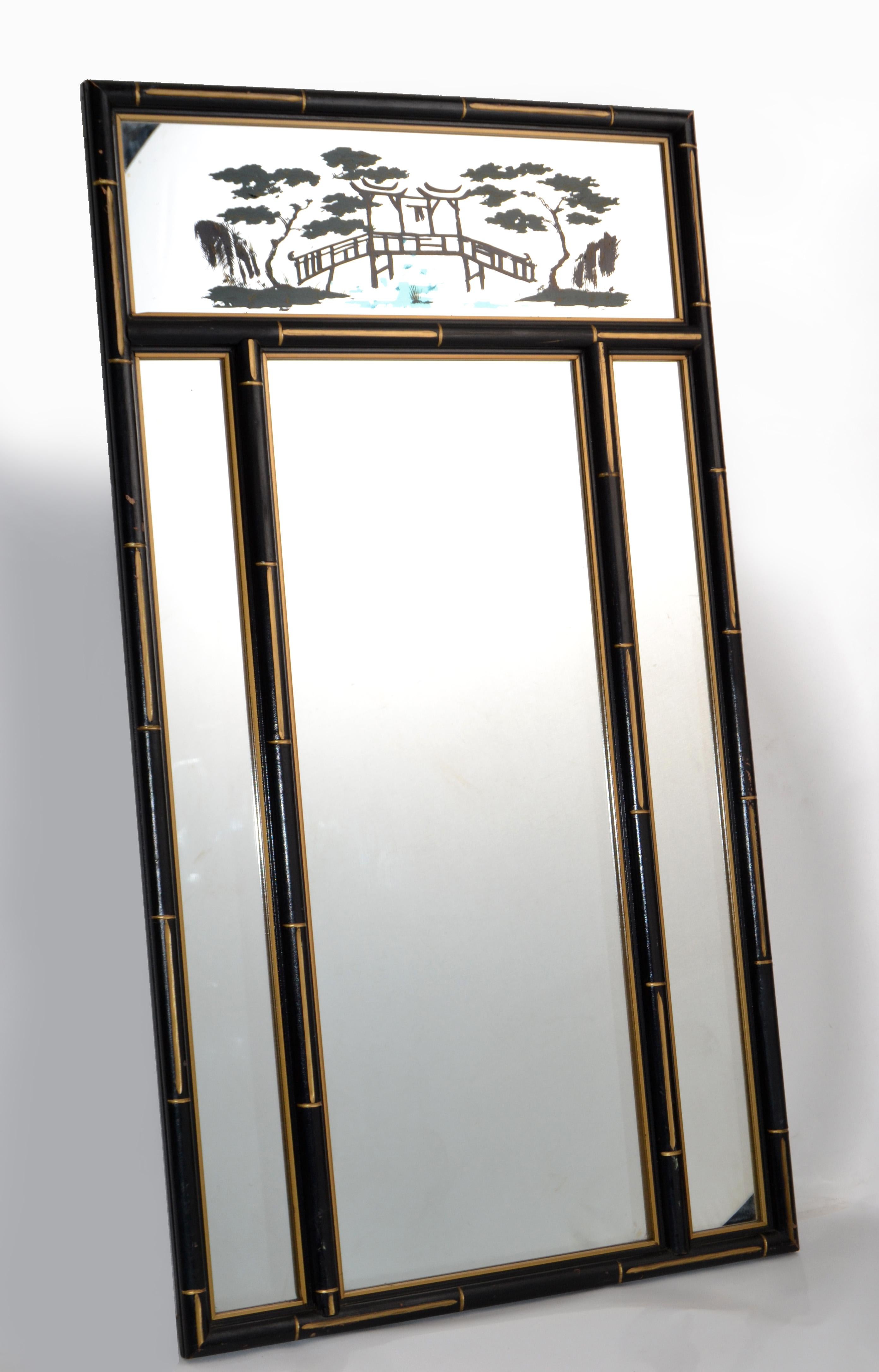 Chinoiserie faux bamboo wall mirror black & gold finish of the period Chinese Export 1970.
Mirror size: 23.25 x 44.25 inches.