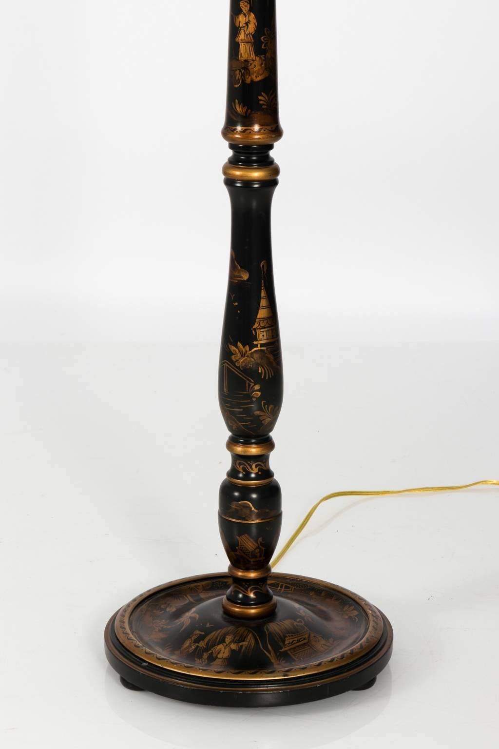 Chinoiserie style floor lamp with gold painted decorative figures, circa 20th century. Shade not included.
 
