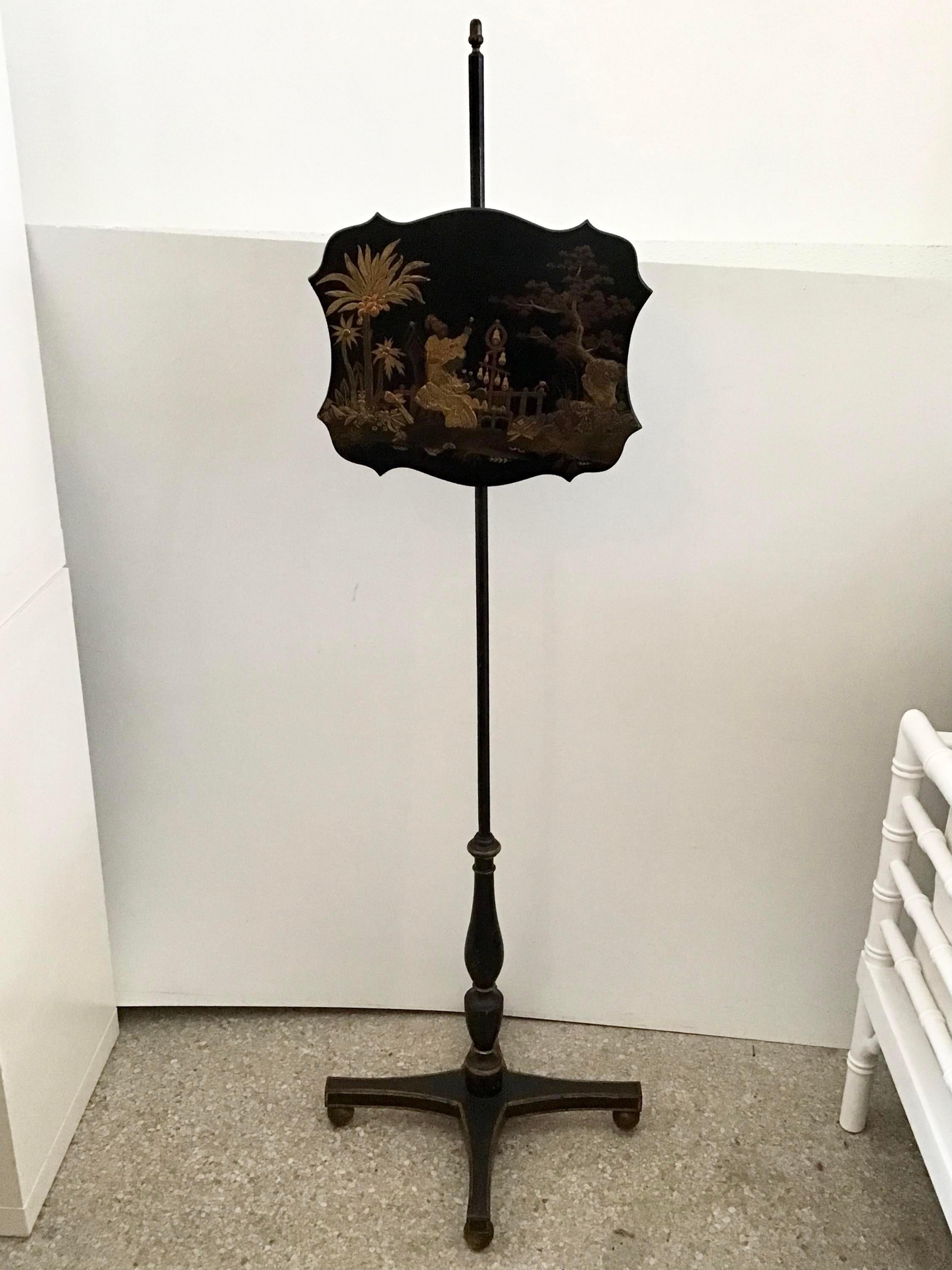 Beautiful Chinoiserie French Fireplace screen decorative art stand. This screen was original crafted to set next to a chair next to a fireplace to keep the direct heat off of your face. The piece includes a painting of an Asian life scene in gold.