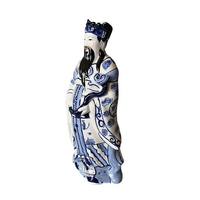 This beautiful blue and white ceramic figurine is of Fu, one of the auspicious Lucky Chinese Gods. They are commonly seen together as a trio which are Fu, Lu, and Shou. Fu is generally depicted in a scholar's dress, holding a scroll, on which is