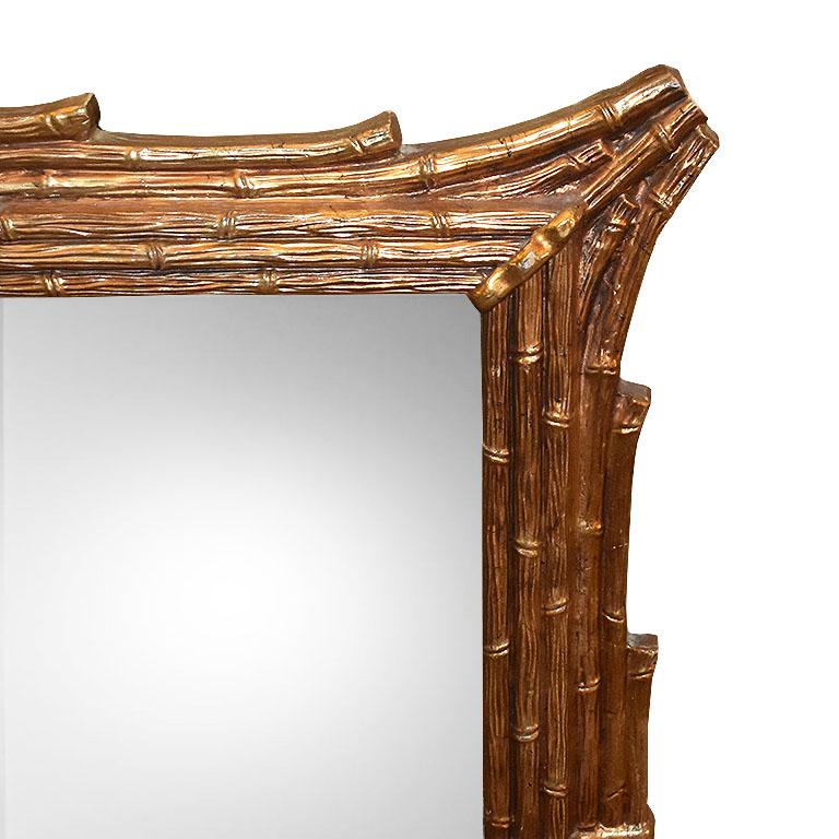 A fabulous chinoiserie gilt mirror with faux bois bamboo detail. A striking way to add interest to any room. This beauty hangs horizontally by wire attached at it's back. Faux bamboo or faux bois details decorate its exterior in lovely gilt bronze