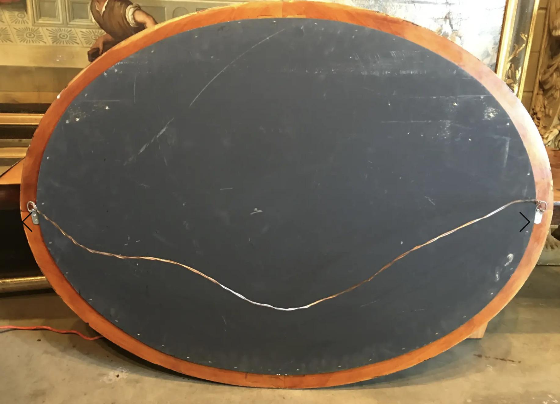 Chinese Chinoiserie Gold Bamboo Leaves on Black Frame With Antiqued Oval Smoky Mirror For Sale